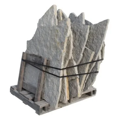 A pallet of large, irregularly shaped stone slabs secured with black straps.
