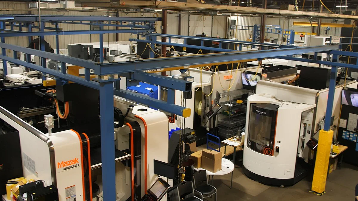 aerospace precision machining Industrial manufacturing workspace with automated machines and equipment.