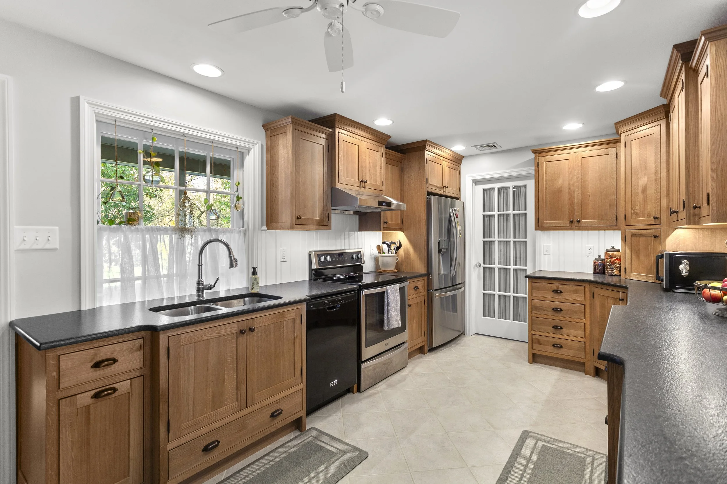 Custom kitchen cabinetry and millwork by residential designer featuring handcrafted wood cabinets, detailed trim, and functional built-in storage