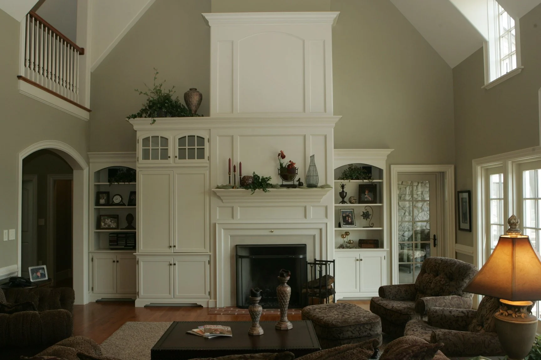 Custom living room with built-in cabinetry, millwork, and a classic fireplace in a traditional home