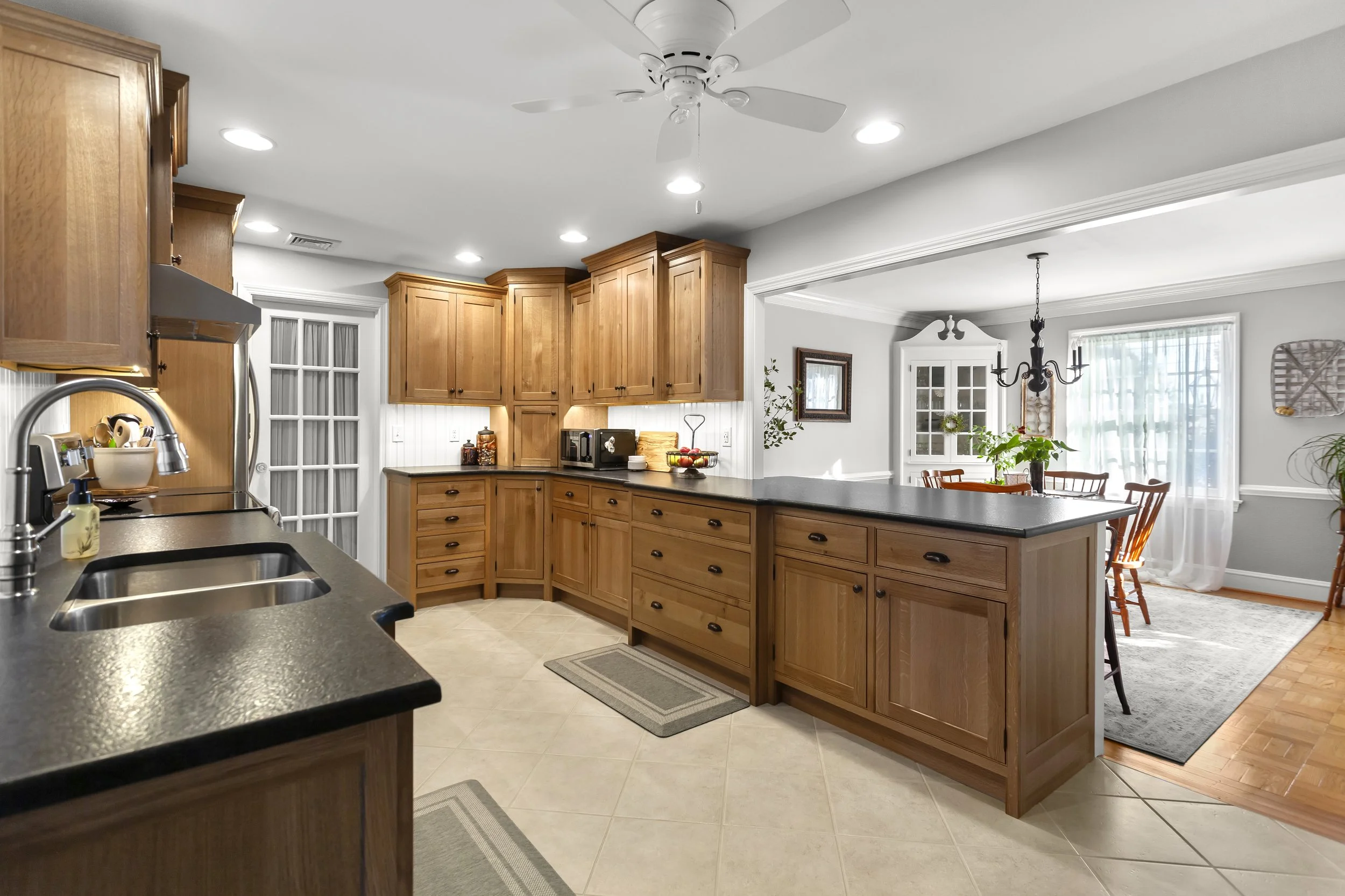 Custom kitchen cabinetry and millwork by residential designer featuring handcrafted wood cabinets, detailed trim, and functional built-in storage