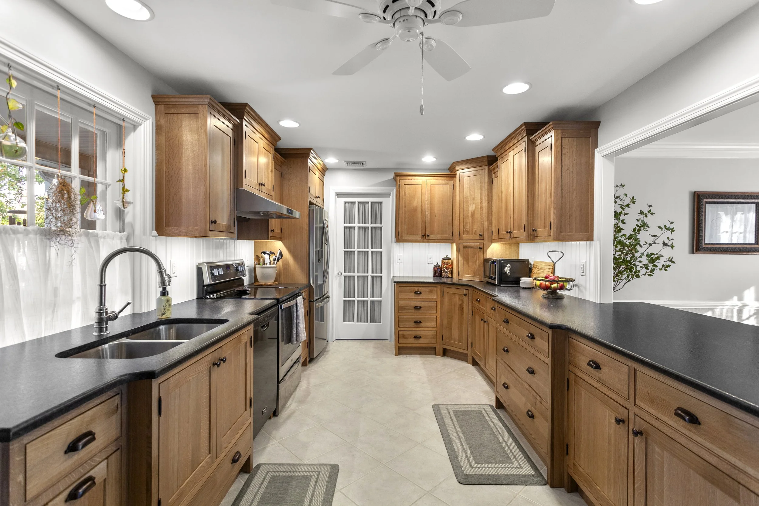 Custom kitchen cabinetry and millwork by residential designer featuring handcrafted wood cabinets, detailed trim, and functional built-in storage