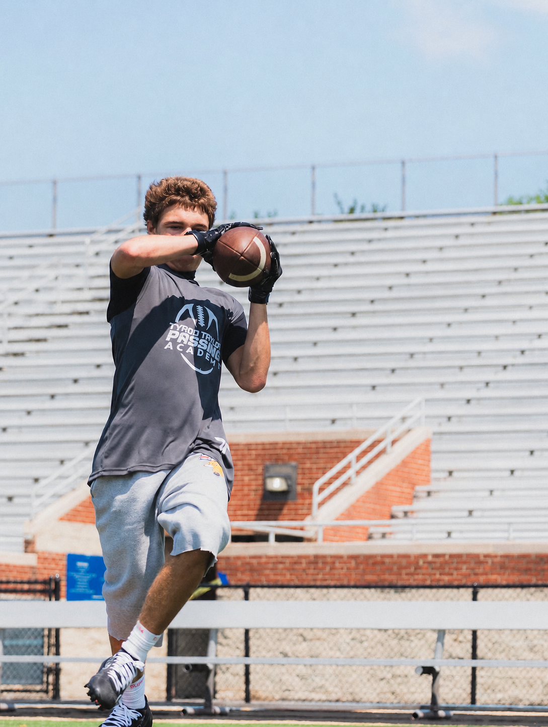 A quarterback completing a throwing drill at the passing academy.