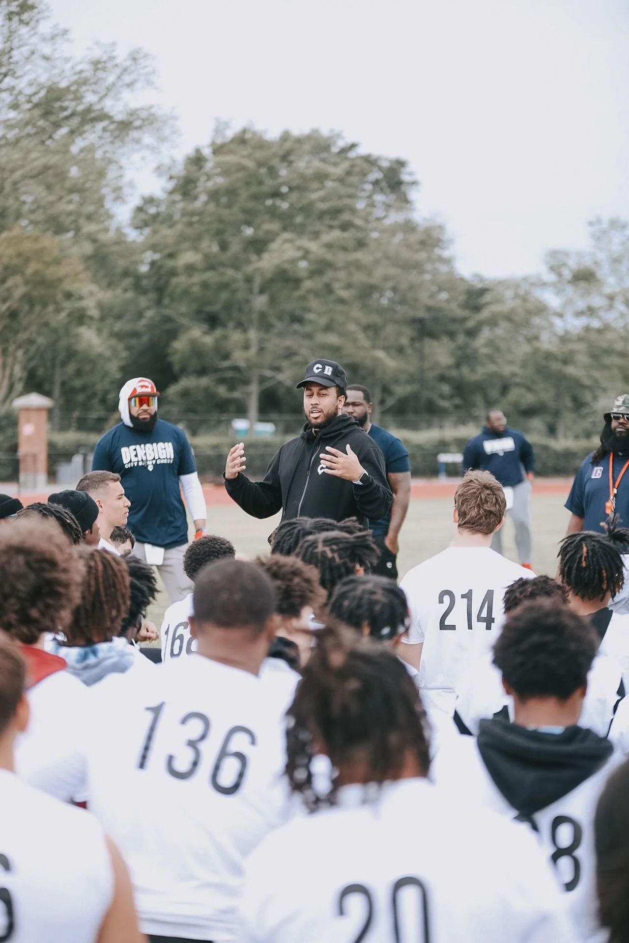 Tommy Reamon speaking with young athletes at his football camp