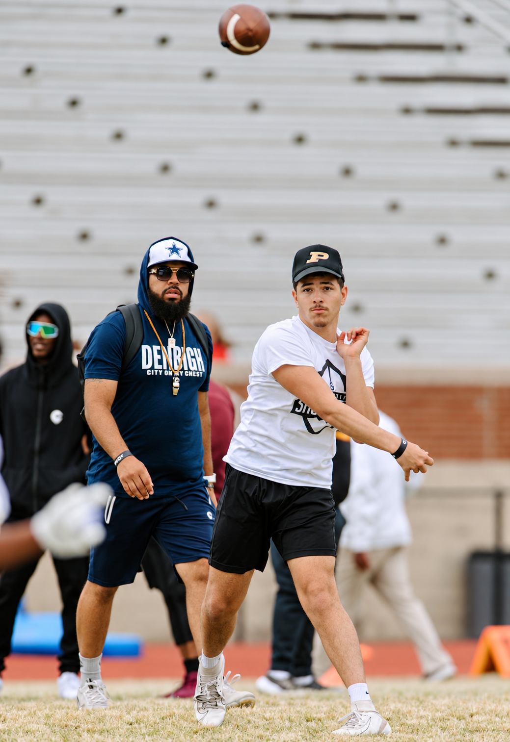 A quarterback working through a passing drill at the 2023 Peninsula Showcase.