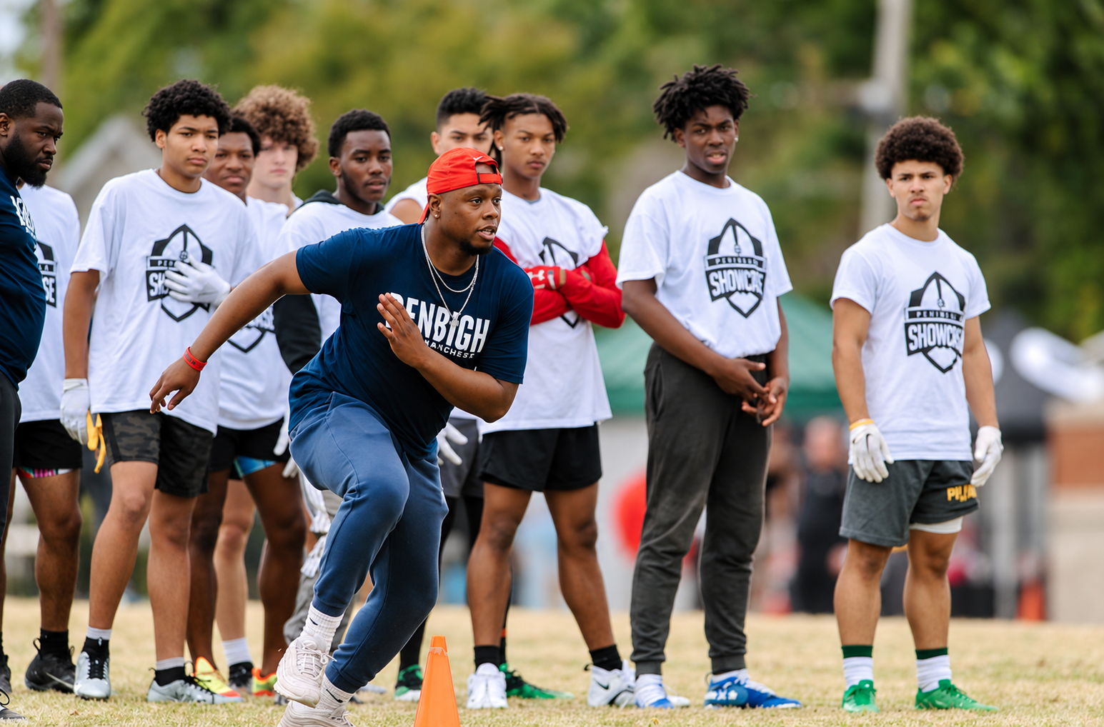 A coach demonstrating technique to athletes at the 2023 Peninsula Showcase.