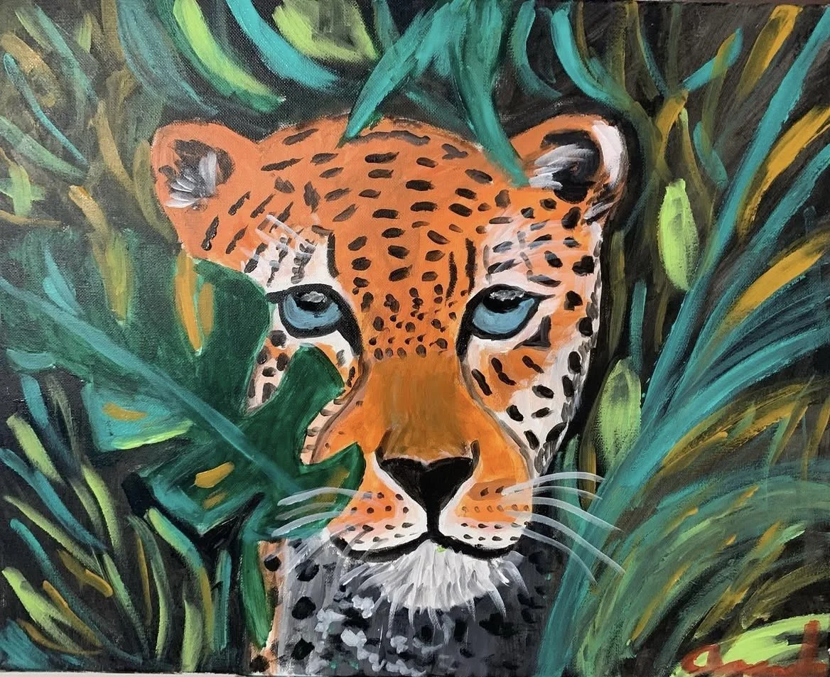 A painting of a jaguar's face with blue eyes, surrounded by lush green tropical leaves.