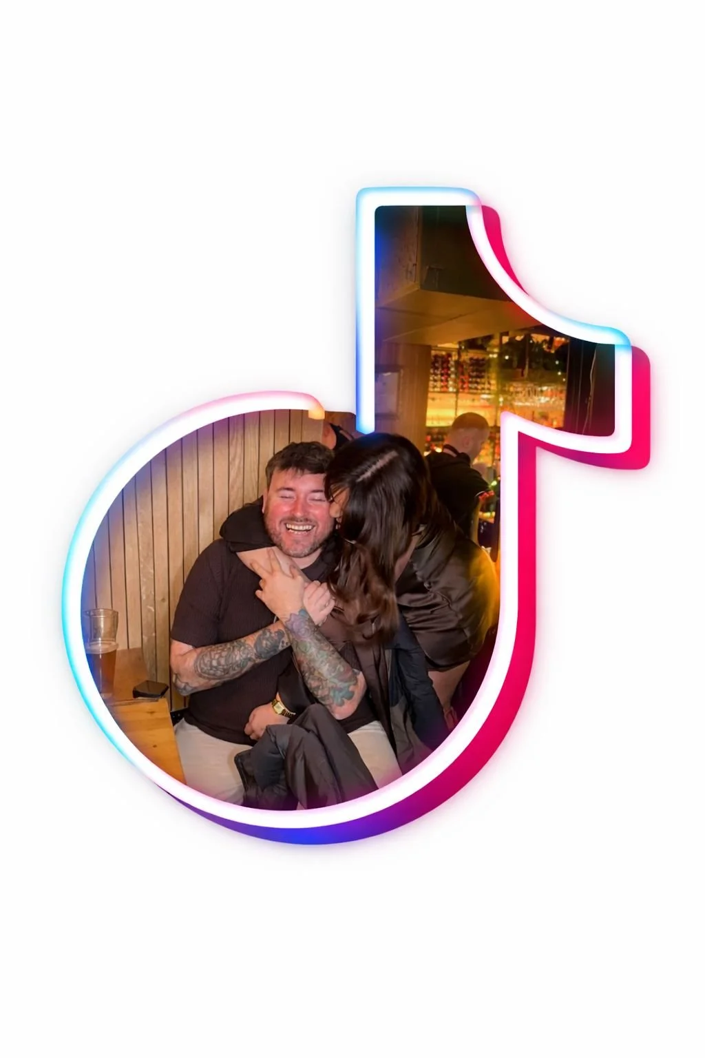 A neon TikTok logo with a photo of a man and a woman hugging inside it, in a bar or restaurant setting.