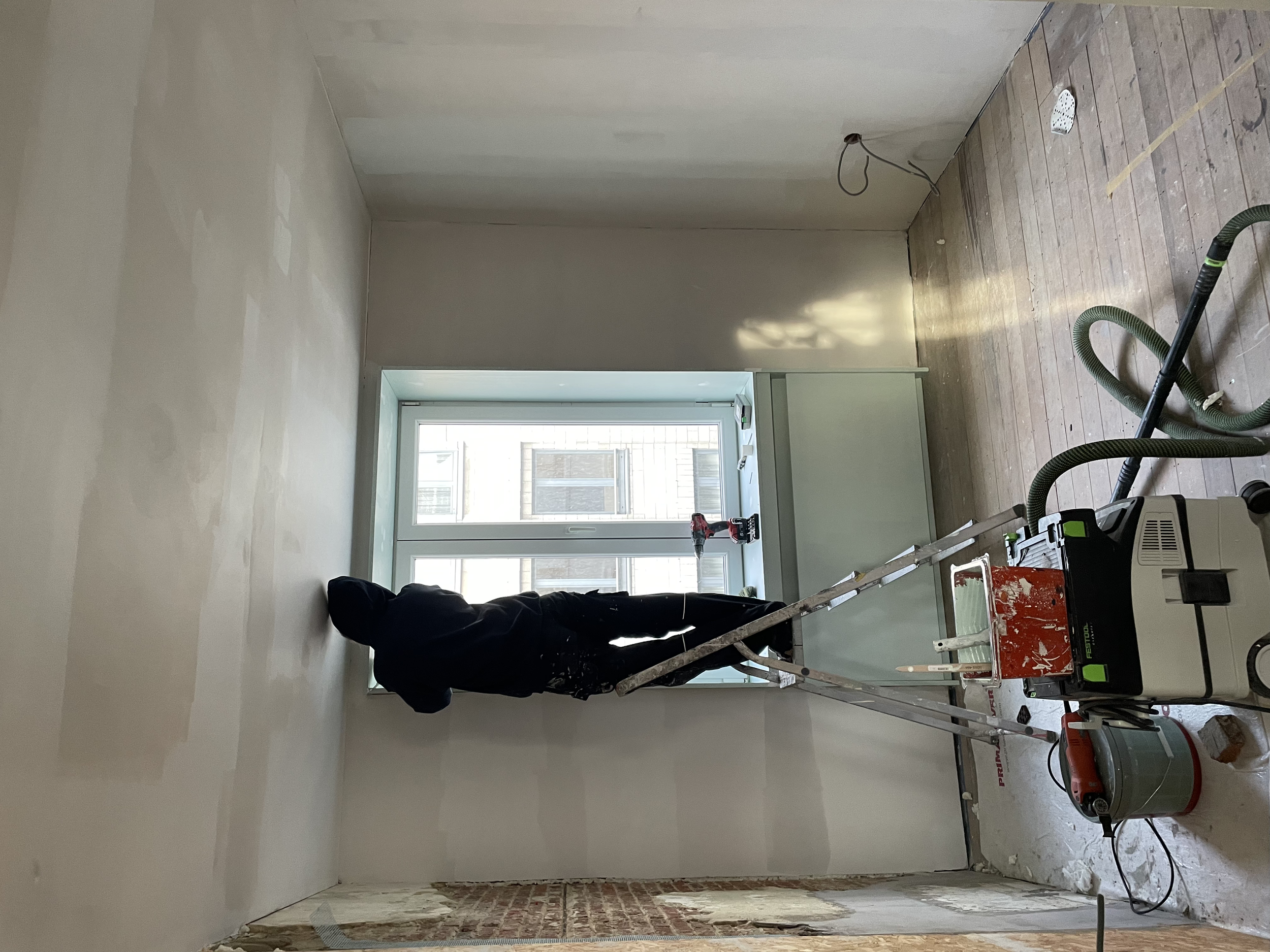 het kader rond het raam en rond de verwarming wordt geschilderd met een matte lak verf. 