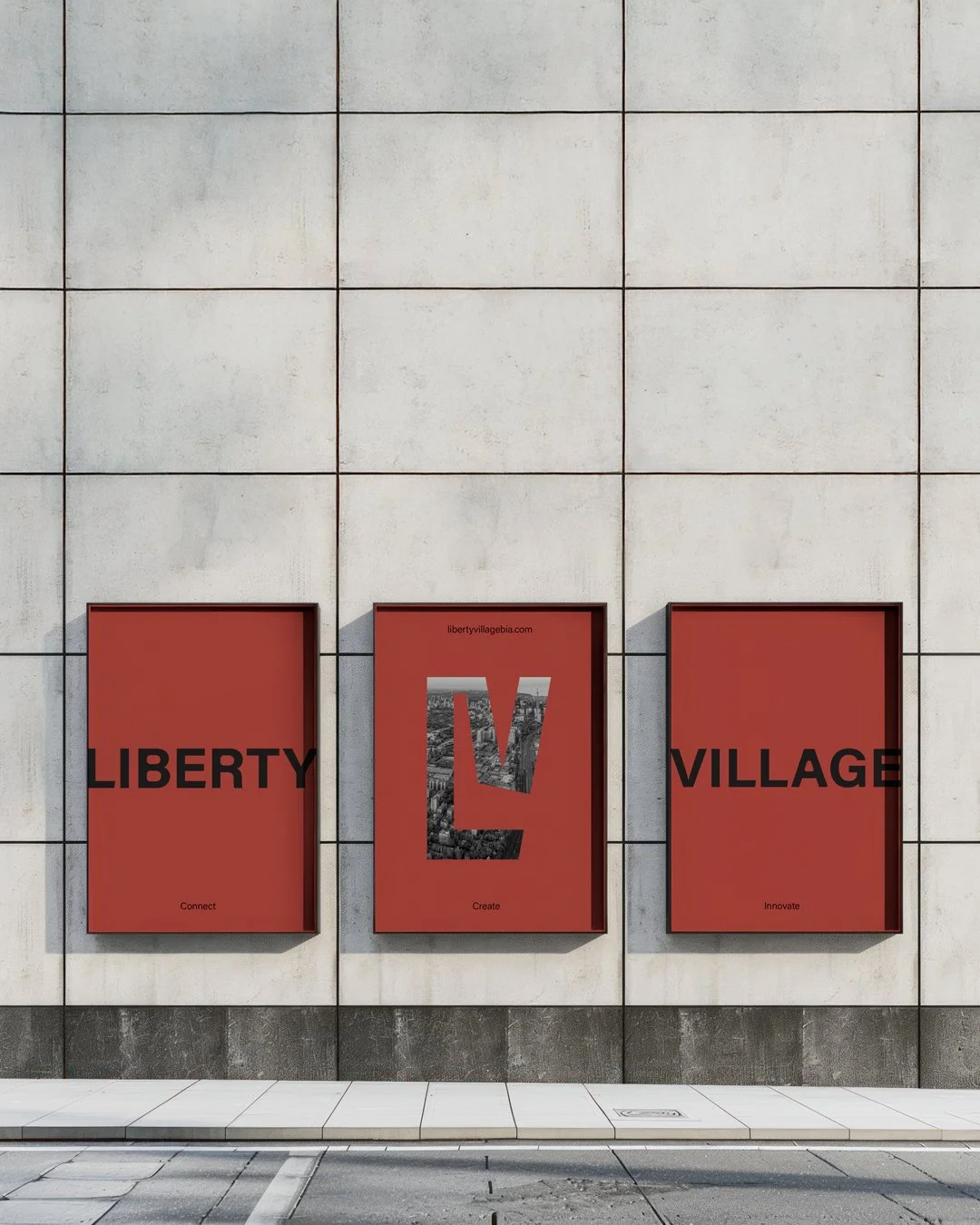 Three red posters on a beige wall. The posters spell out 'LIBERTY VILLAGE' with the middle poster showing a large 'L' filled with a cityscape, and smaller words underneath each poster reading 'Connect,' 'Create,' and 'Innovate.'