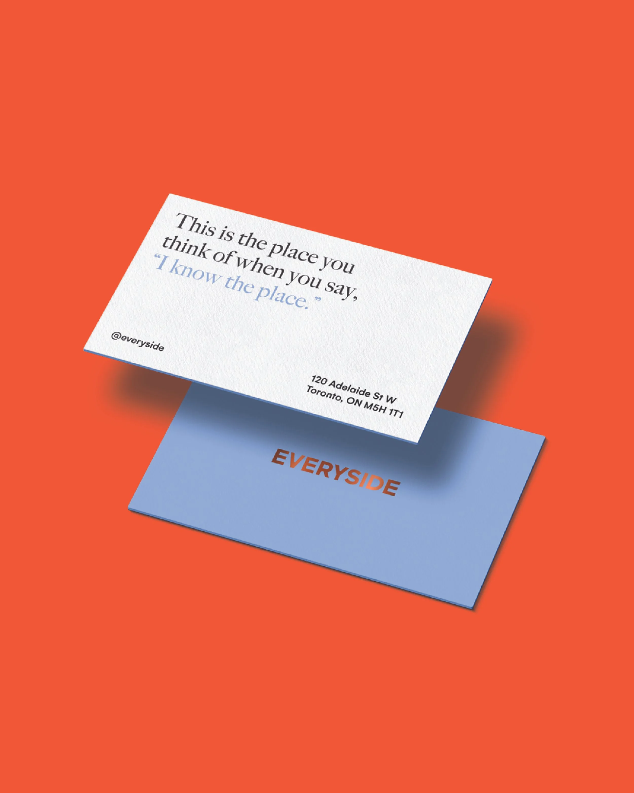 Business cards on an orange background, one displaying a quote about a place and the other with the company name 'EVERYSIDE' in orange text on a blue card.