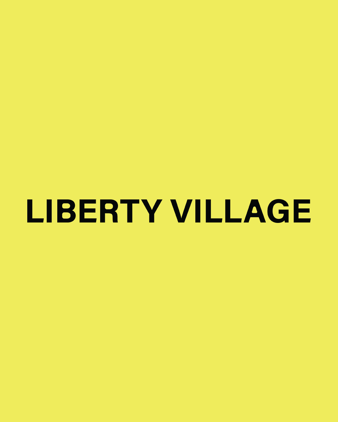 A yellow background with the words "Liberty Village" written in black, bold font in the center.