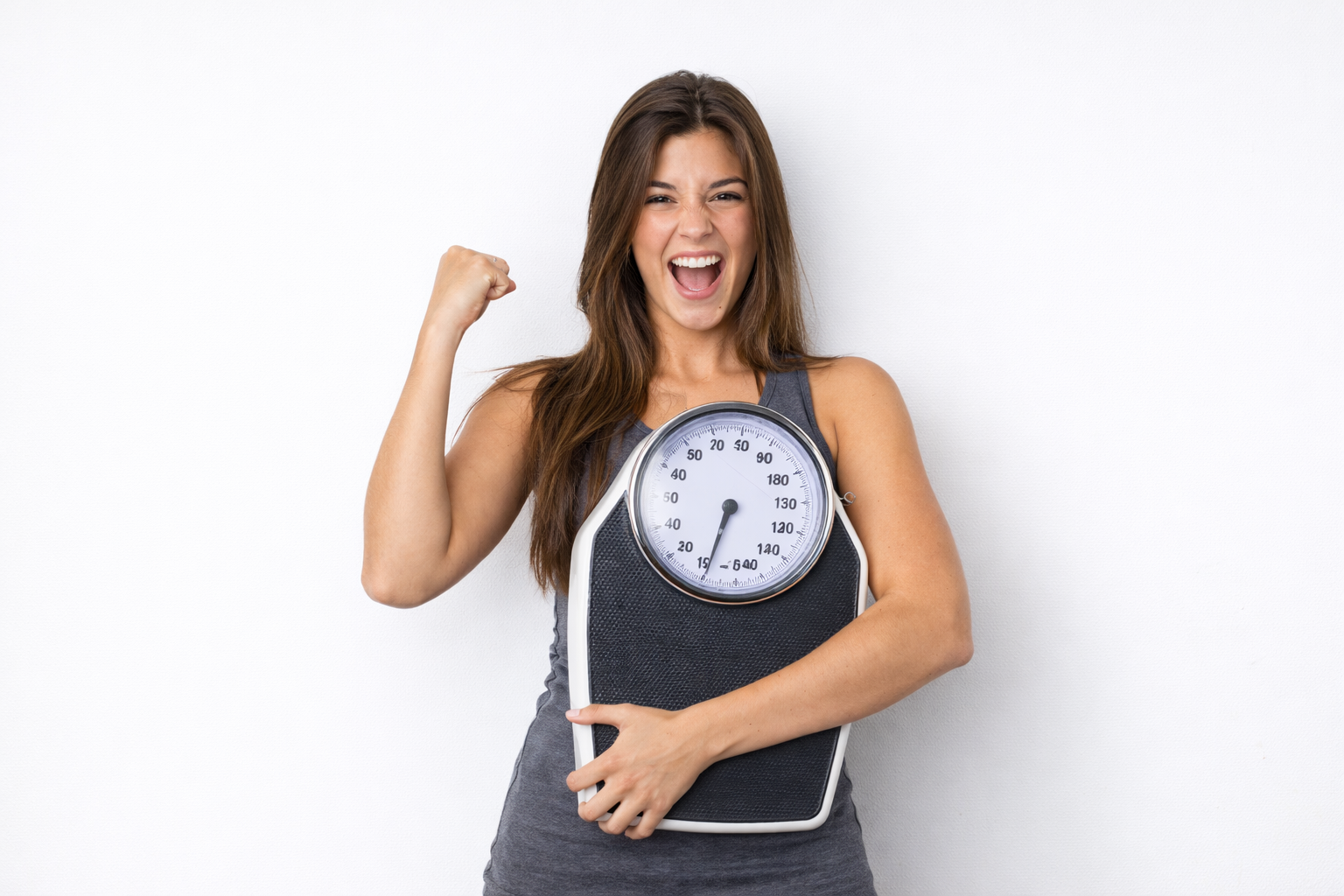 Woman standing with a scale appears happy