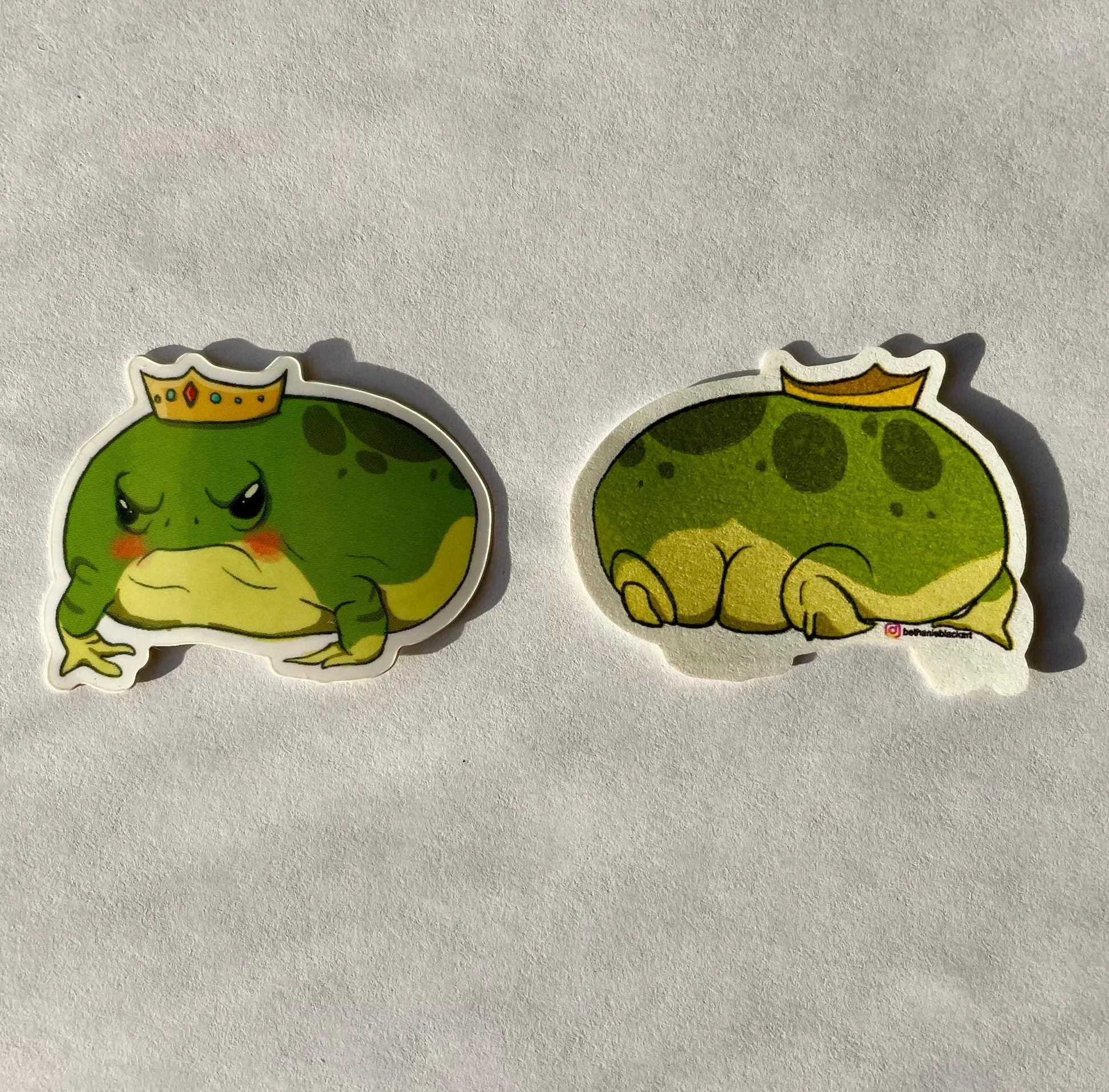 showing front and back of the sticker with the main sticker and then the butt of the frog on the back