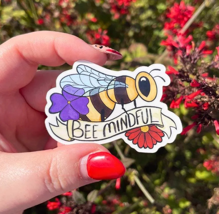 bee sticker with a red and purple flower with the bee on a banner that says bee mindful