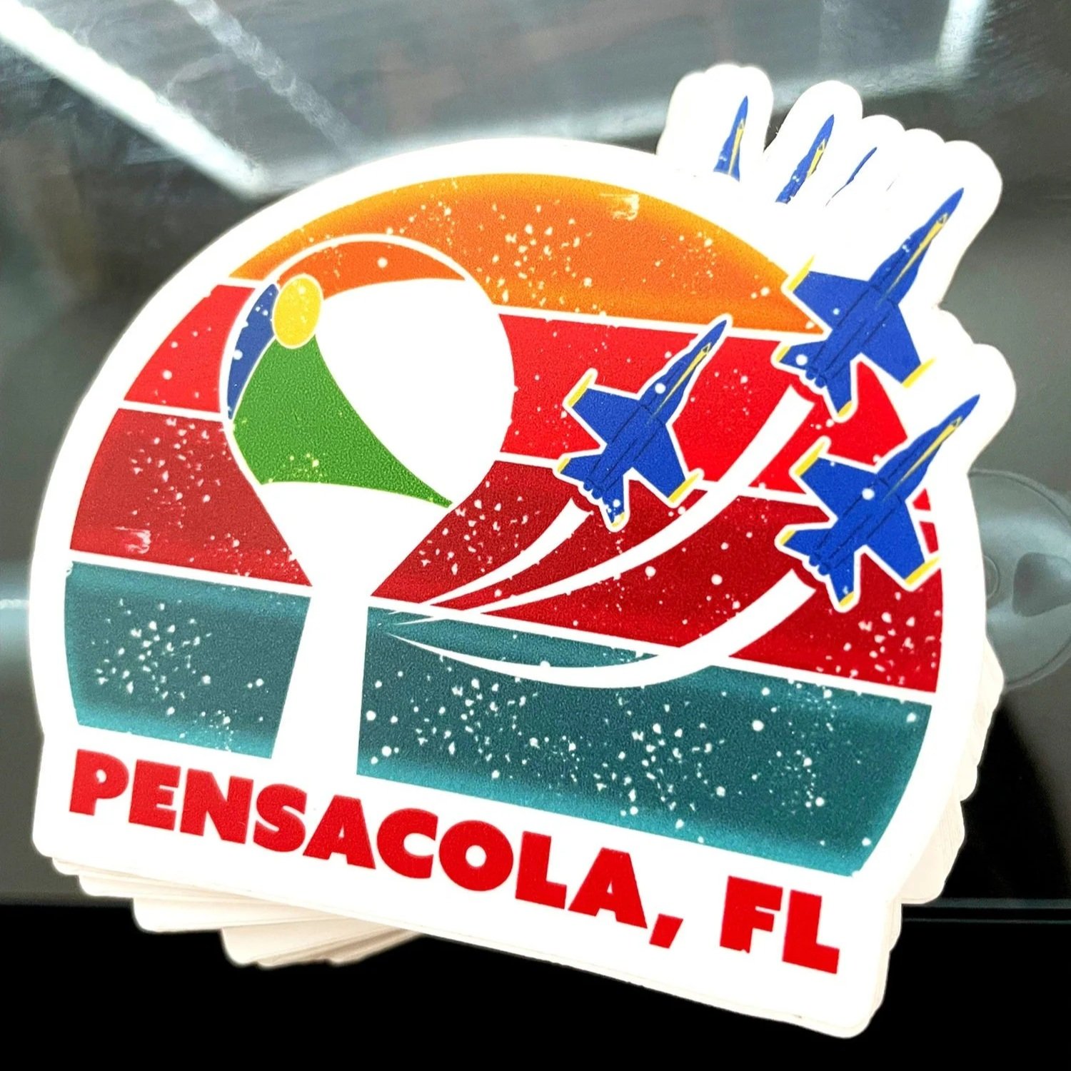 front view of the pensacola sticker on a desk