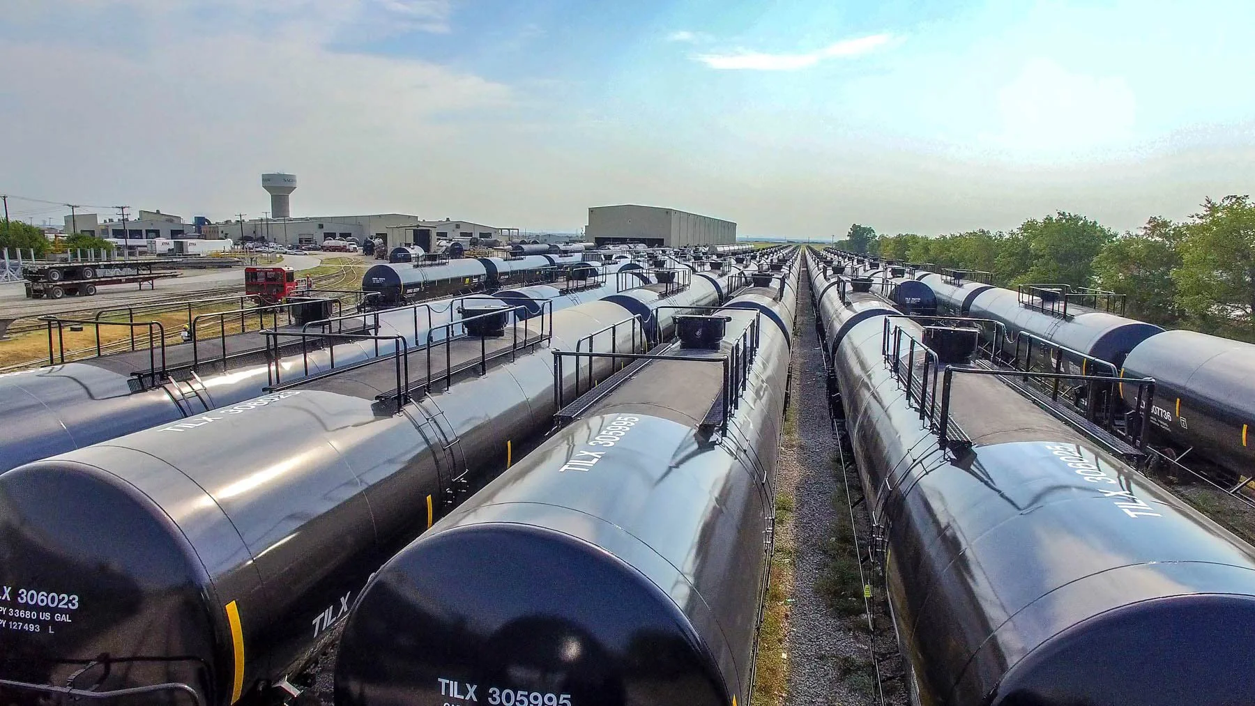 Drone aerial view of a large railcar storage yard with rows of tanker railcars, illustrating logistics scale, industrial operations, and transportation infrastructure for energy and rail industry clients.