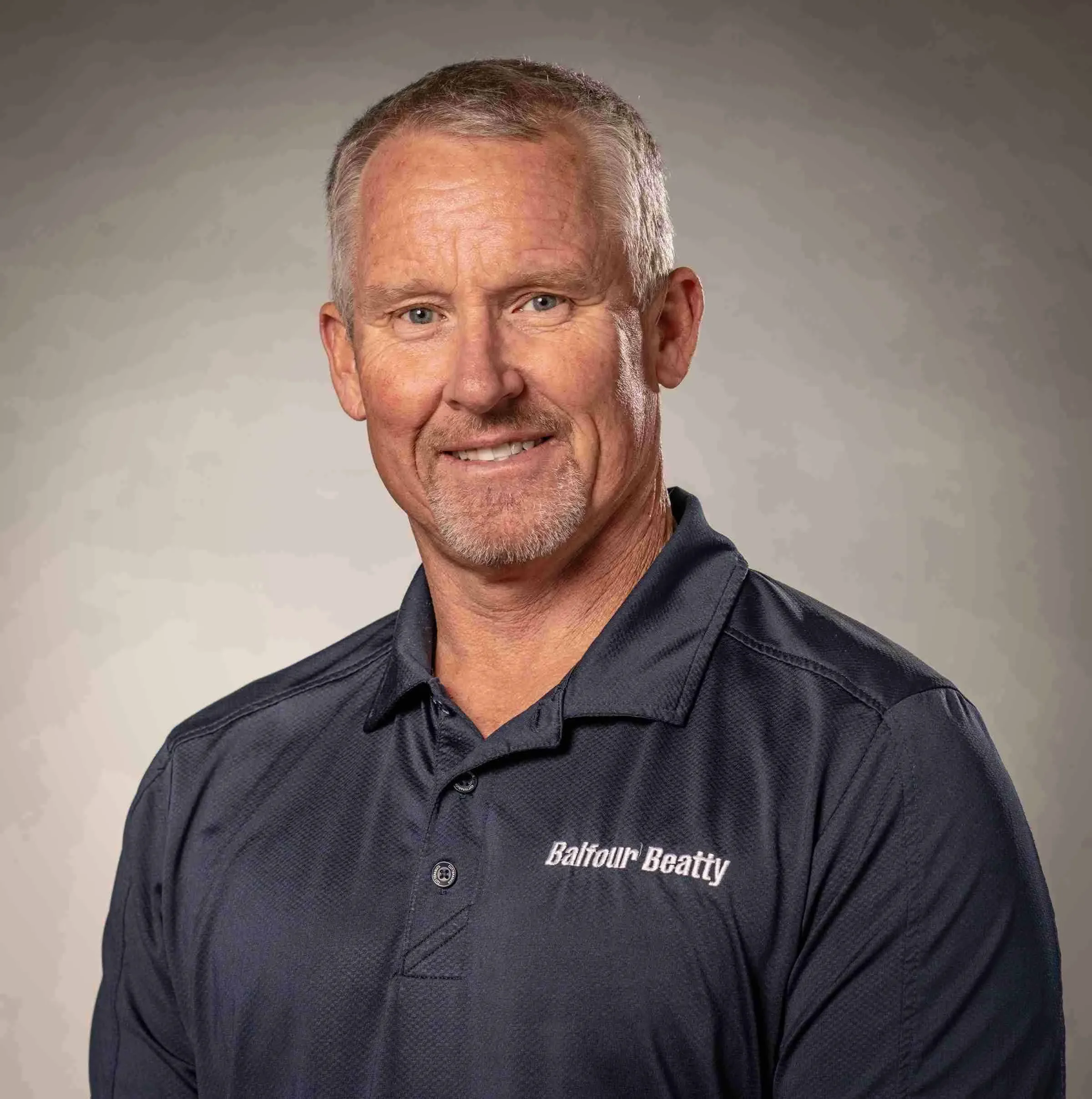 Studio portrait of a Balfour Beatty safety team leader, professionally photographed to convey leadership, accountability, and a strong commitment to workplace safety within large-scale construction and infrastructure projects.