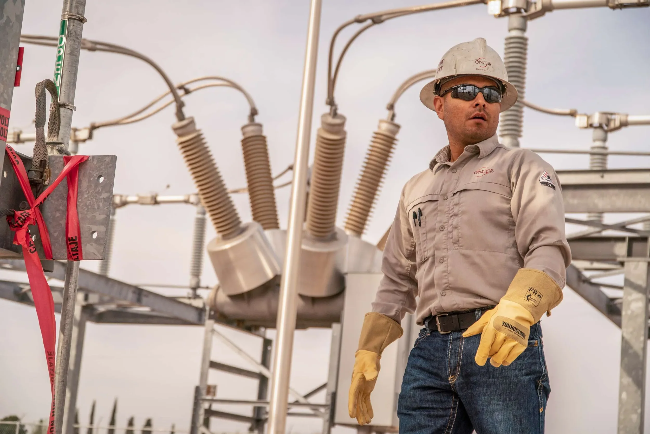 Dallas industrial utility photography featuring an electrical technician working inside a power substation, highlighting grid infrastructure, safety compliance, and critical energy operations.