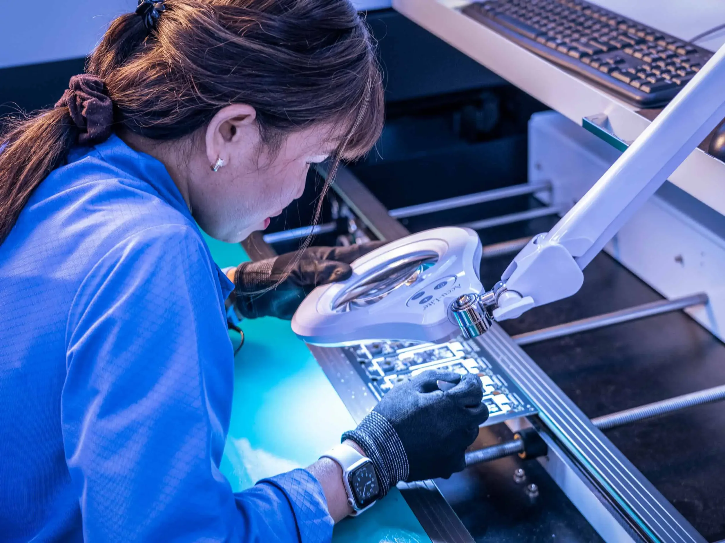 Dallas industrial manufacturing photography of precision electronic component inspection. Professional documentation of quality control processes, advanced manufacturing, and skilled labor by C Ray Pictures.