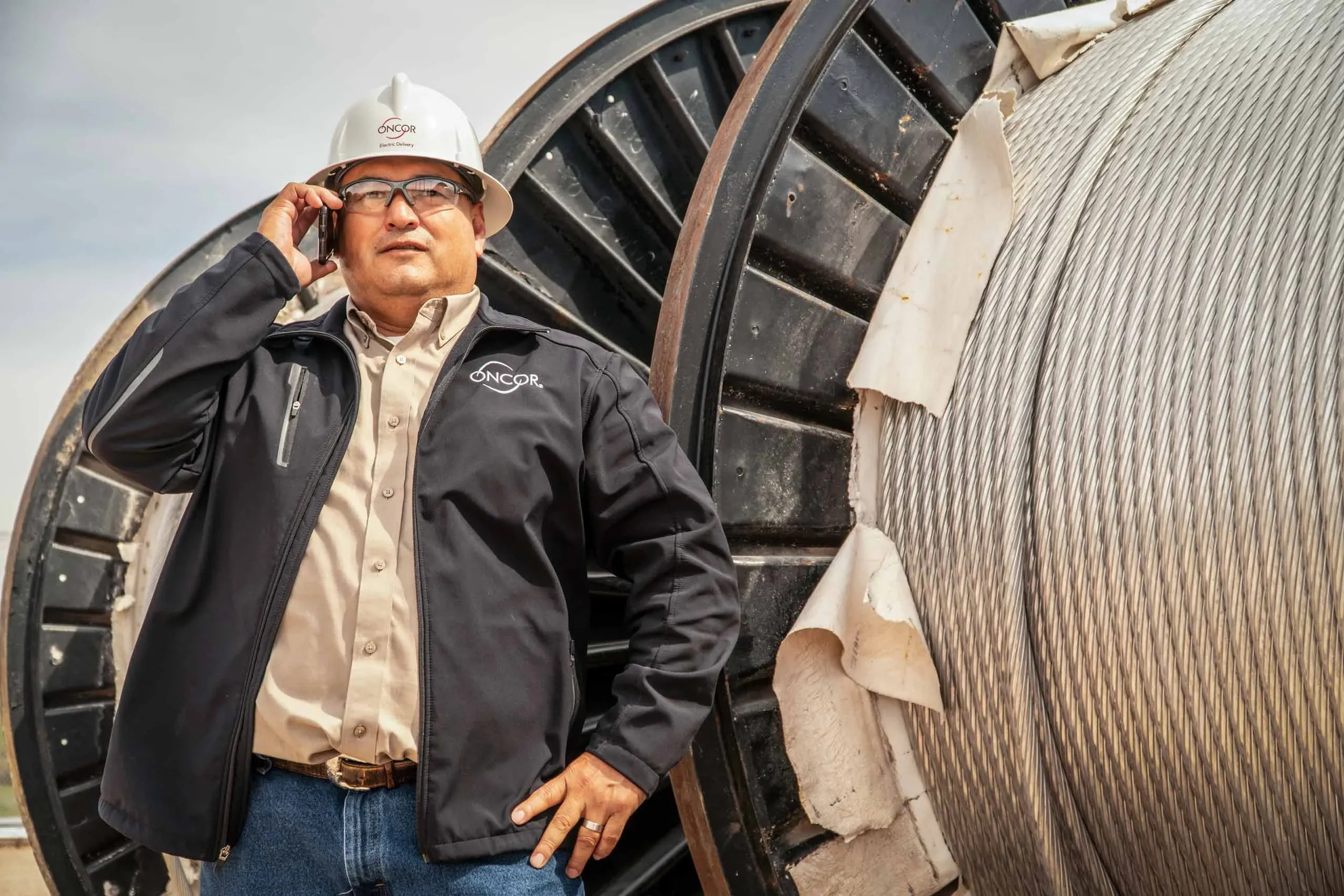 Environmental corporate portrait of a utility professional photographed on location beside critical infrastructure. This image highlights leadership, field operations, and decision-making, ideal for corporate marketing, annual reports, and business s