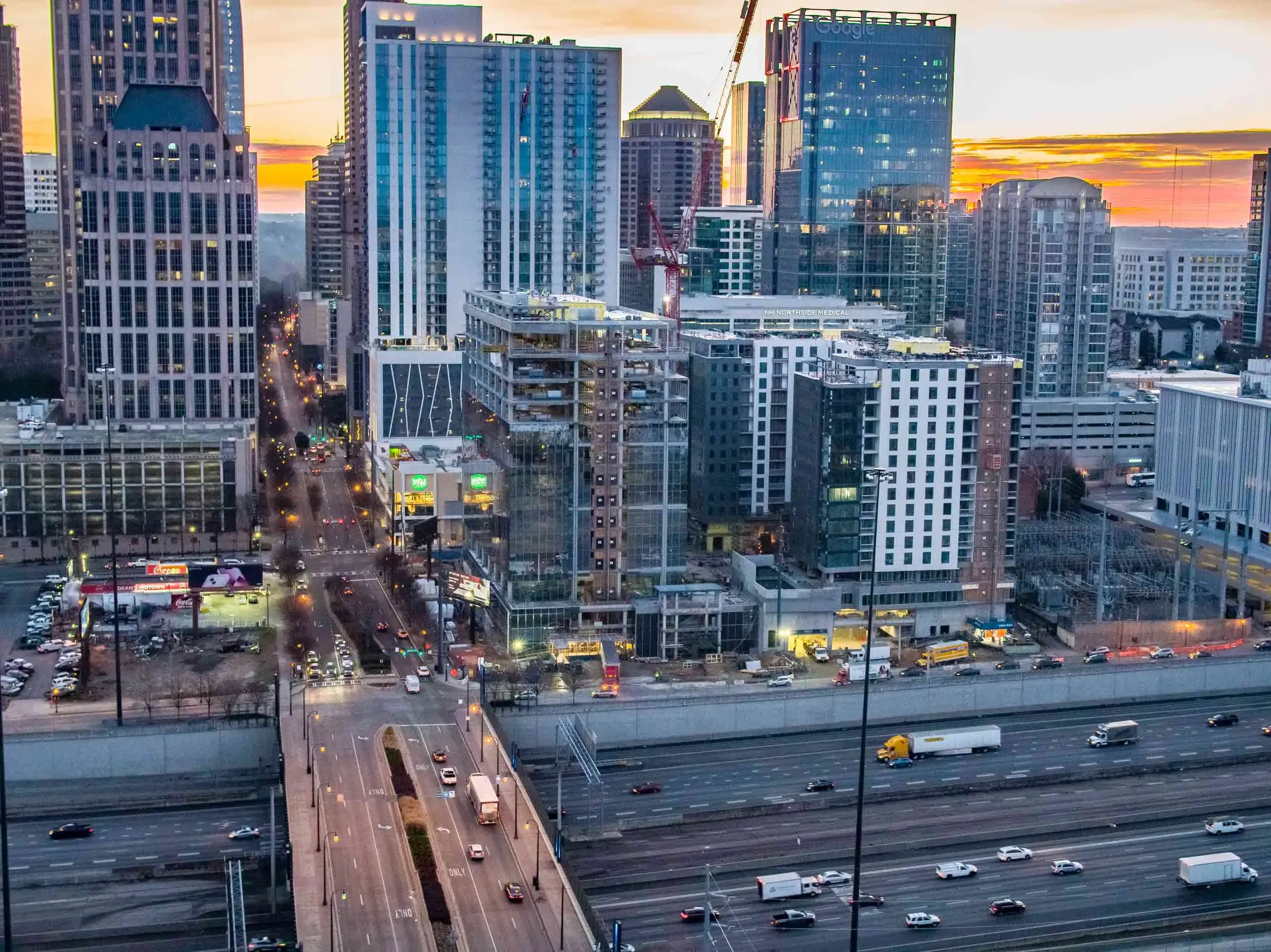 Drone aerial view of downtown Dallas during sunset, capturing high-rise construction, active development corridors, and urban growth through architectural and construction drone photography.