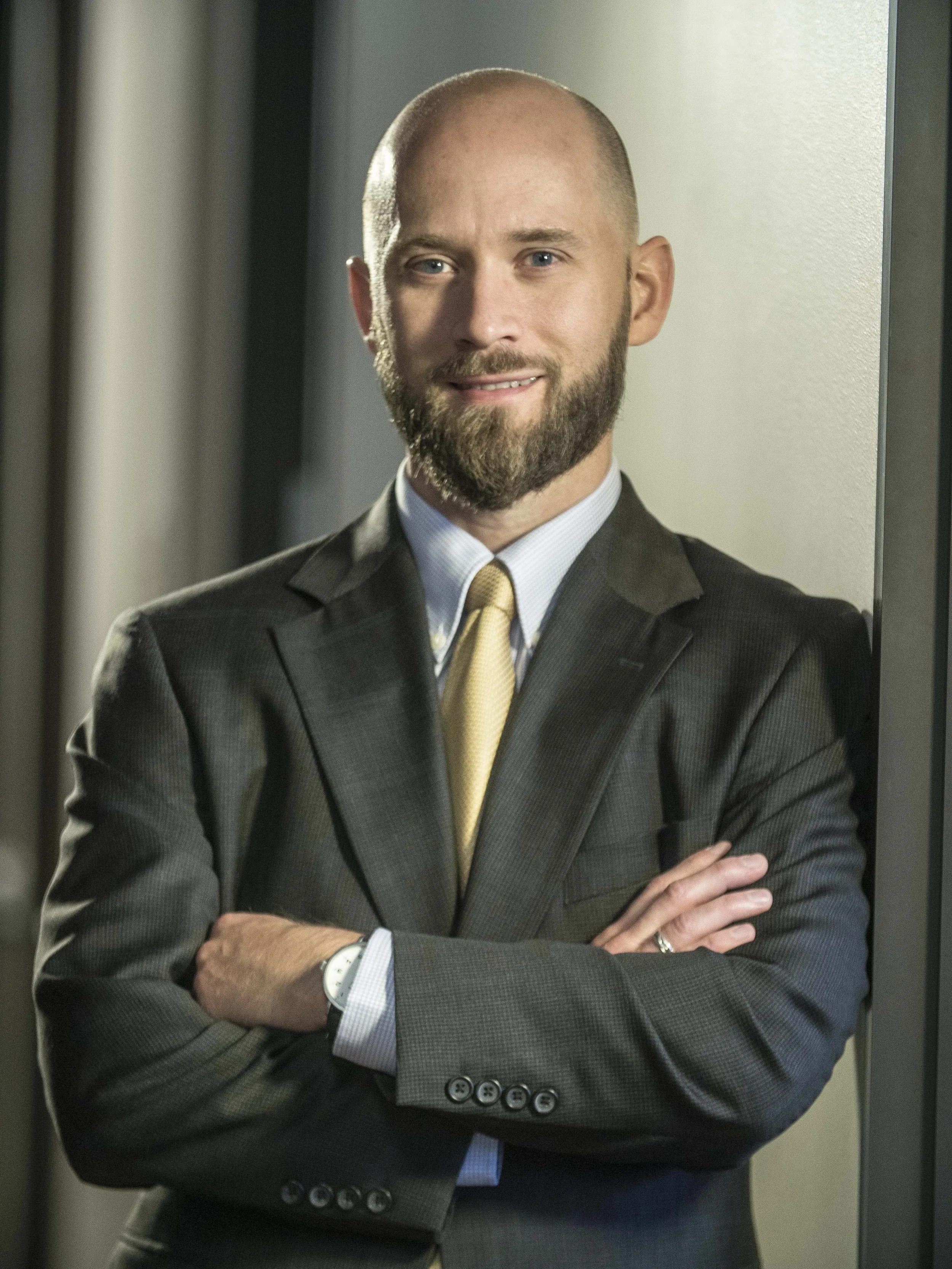 Professional executive portrait of a business leader with arms crossed, photographed to convey confidence, authority, and corporate credibility.