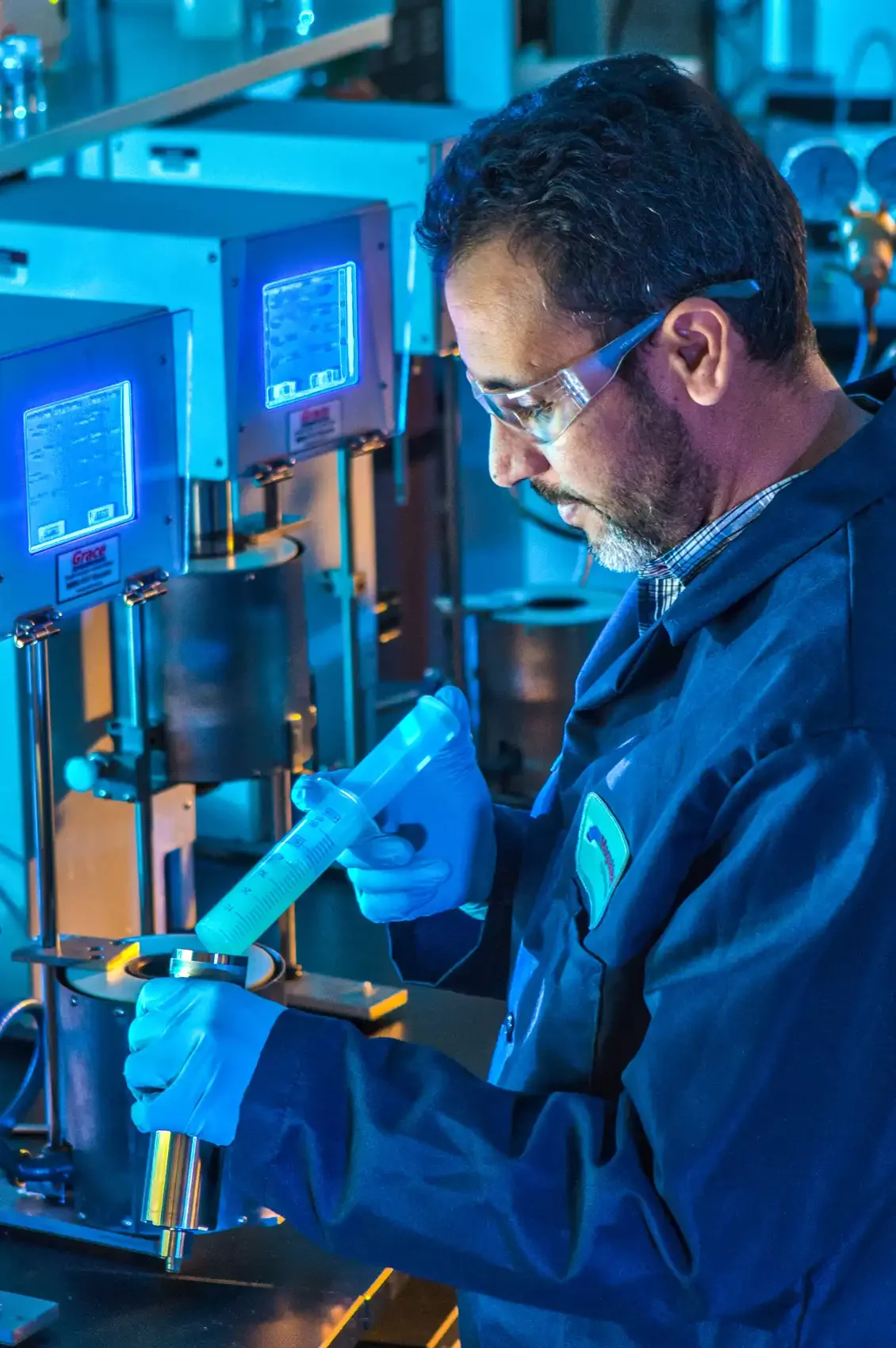 Industrial photography in Dallas featuring a technician conducting precision laboratory testing using specialized equipment, highlighting process control, material analysis, and industrial quality assurance.