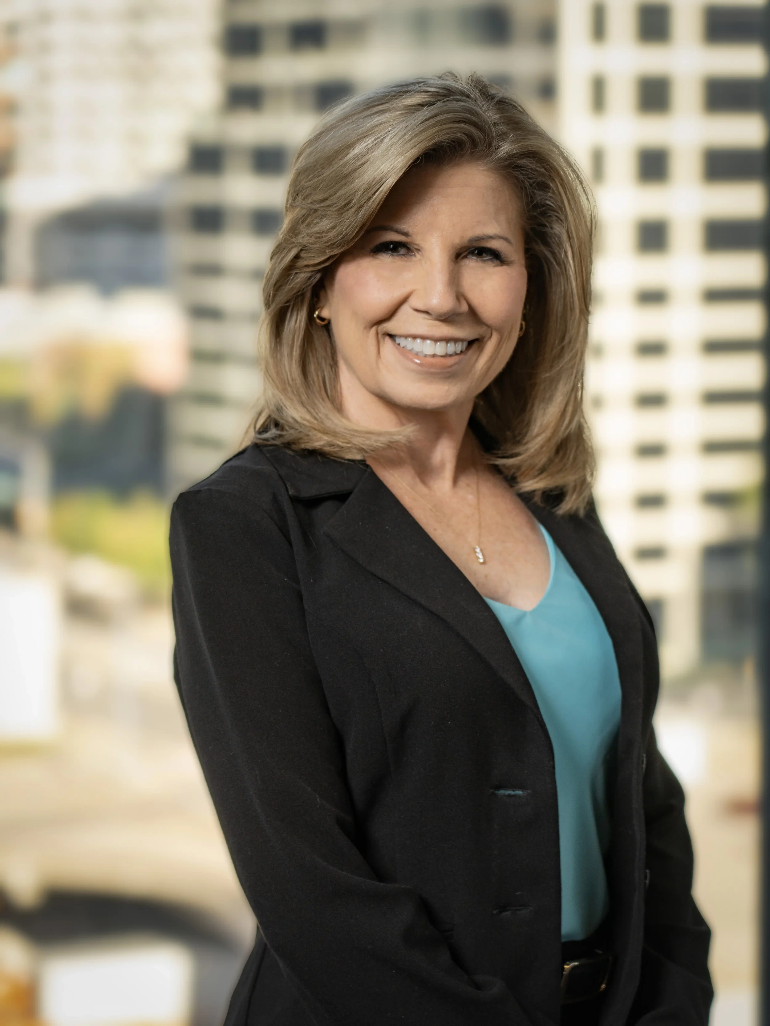 Professional corporate headshot photographed in a natural urban setting, highlighting executive presence, confidence, and approachability. This image supports personal branding, corporate websites, leadership profiles, and business marketing material