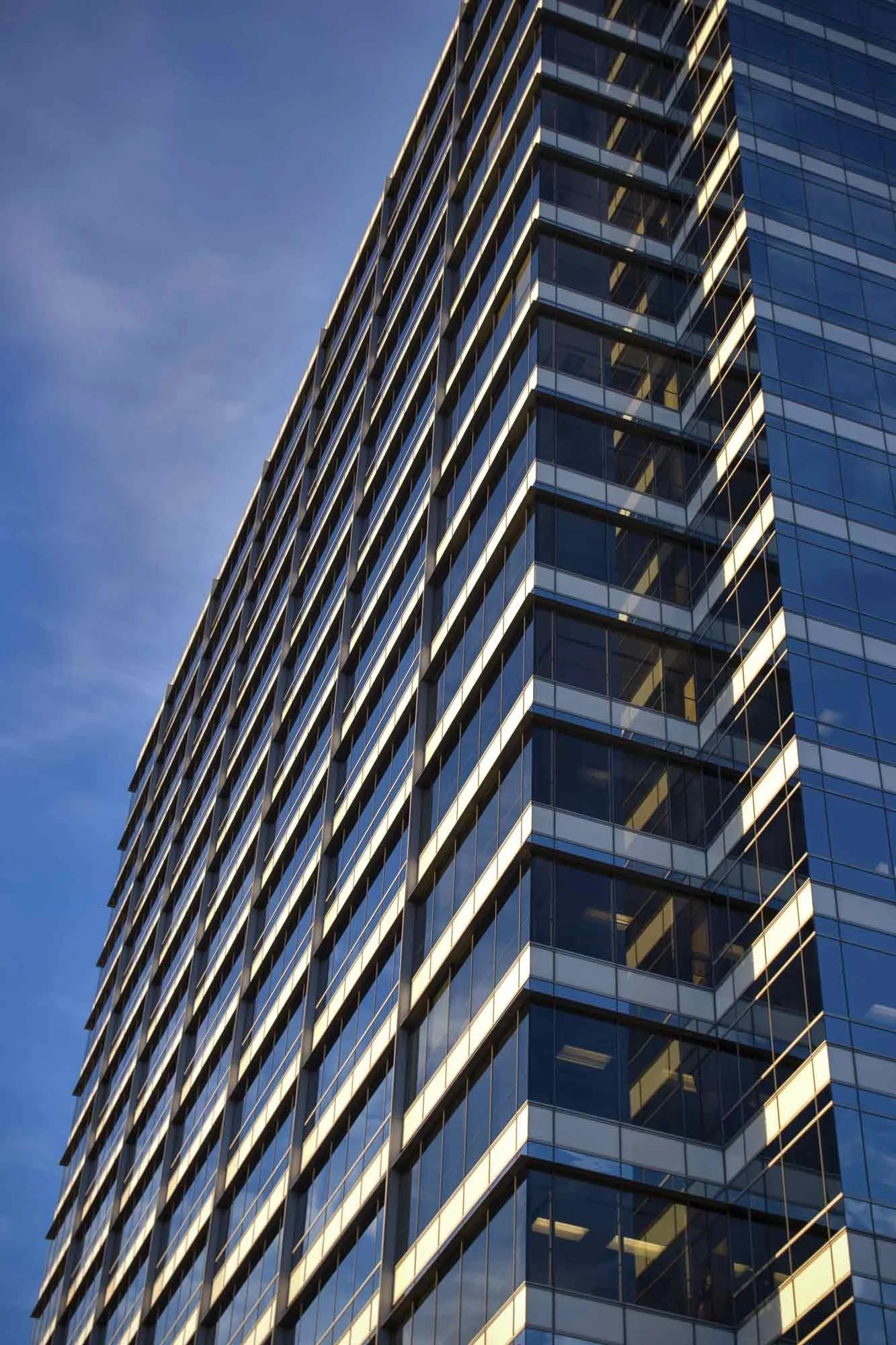 Graphic architectural photography of a Houston high-rise office building featuring bold geometric lines and modern glass facade, captured by C Ray Pictures.