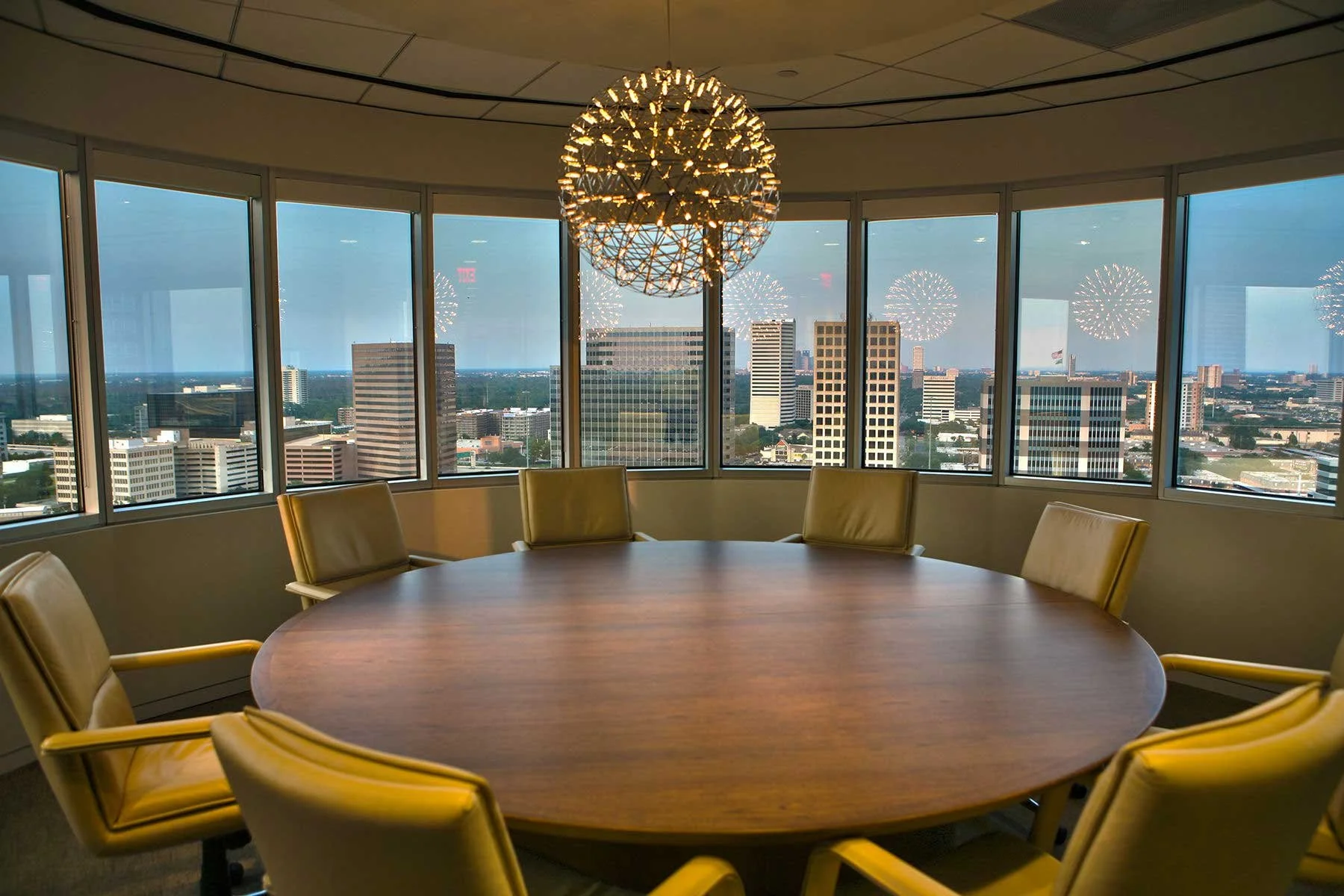 Interior architectural photography of a modern conference room featuring a large round table and floor-to-ceiling windows with natural light, by C Ray Pictures.