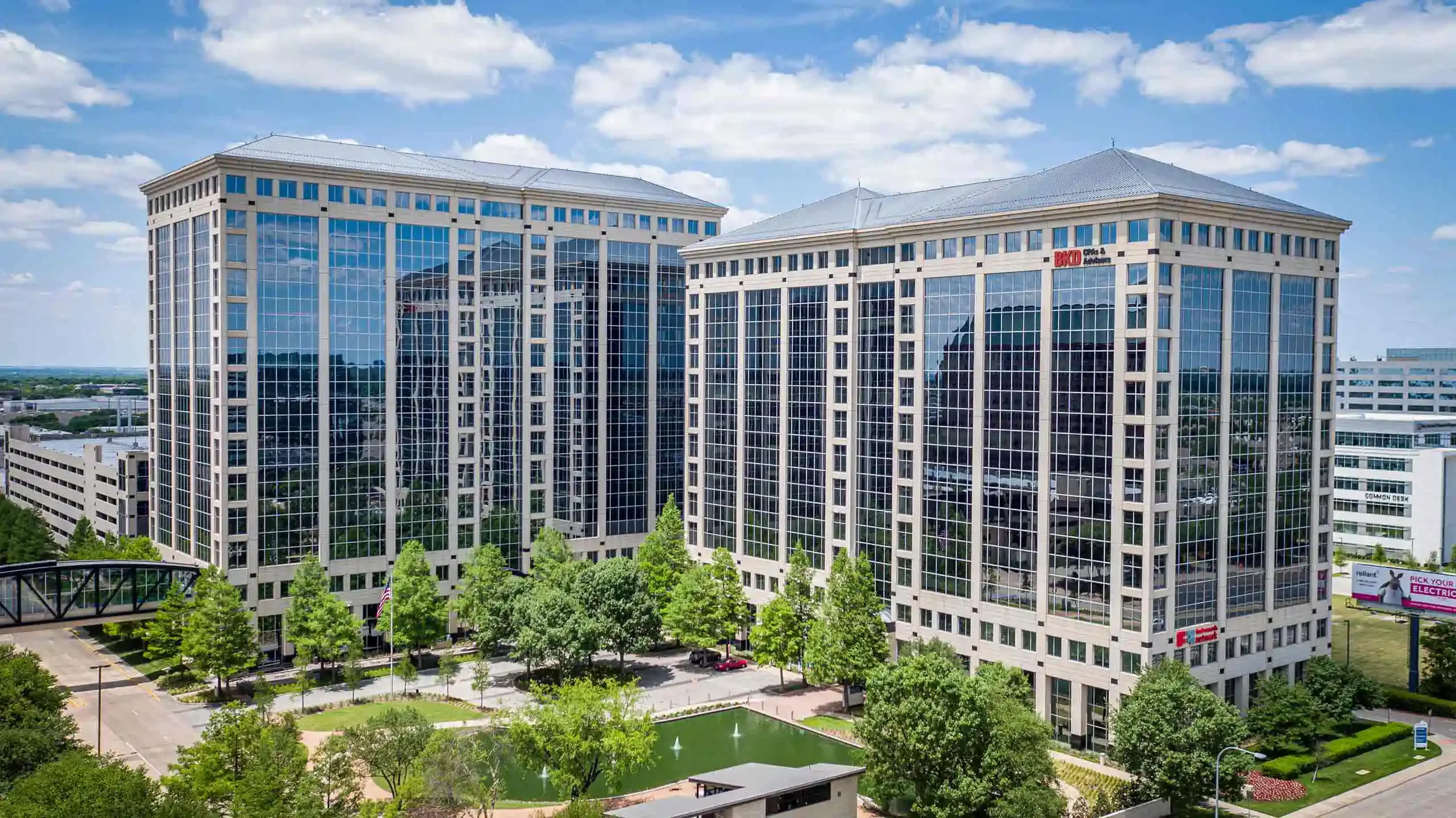 Drone image of a multi-building corporate office campus with landscaped grounds, emphasizing commercial real estate development and executive office environments.
