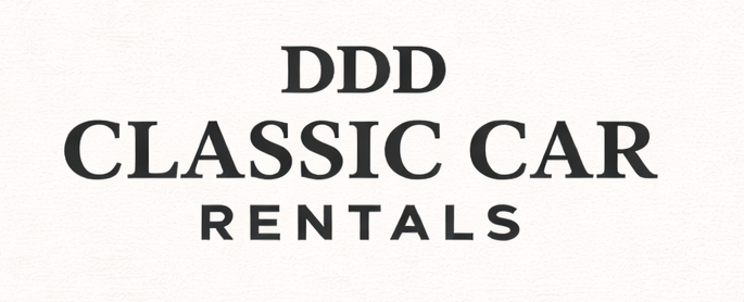 Sign that reads 'DDD Classic Car Rentals' in black text on a white background.