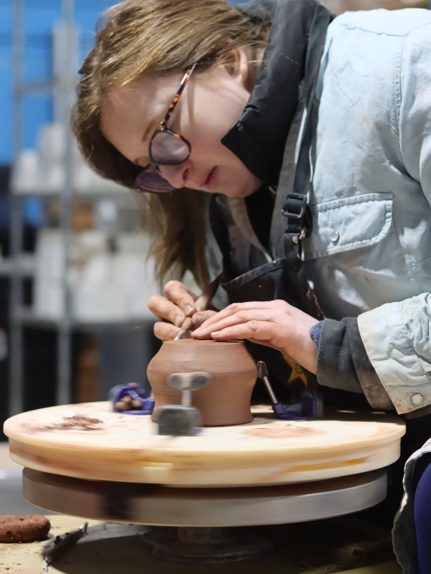 Meet Kelsey (@kcouragedesigns ), trimming her piece on the pottery wheel. Most people don&rsquo;t realize pottery trimming is basically using a lathe - you&rsquo;re cutting away material to reveal your design and clean it up. That&rsquo;s the moment 