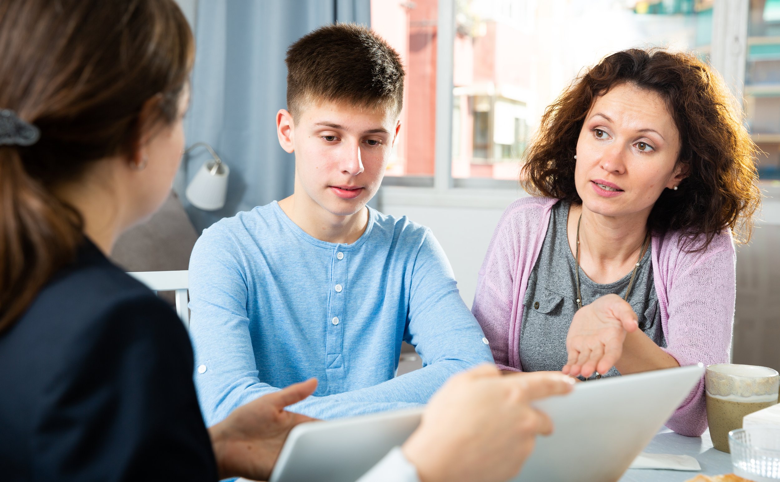 Mother and Son listening to an AllyUp Advocate from JenEd Enterprises Inc.