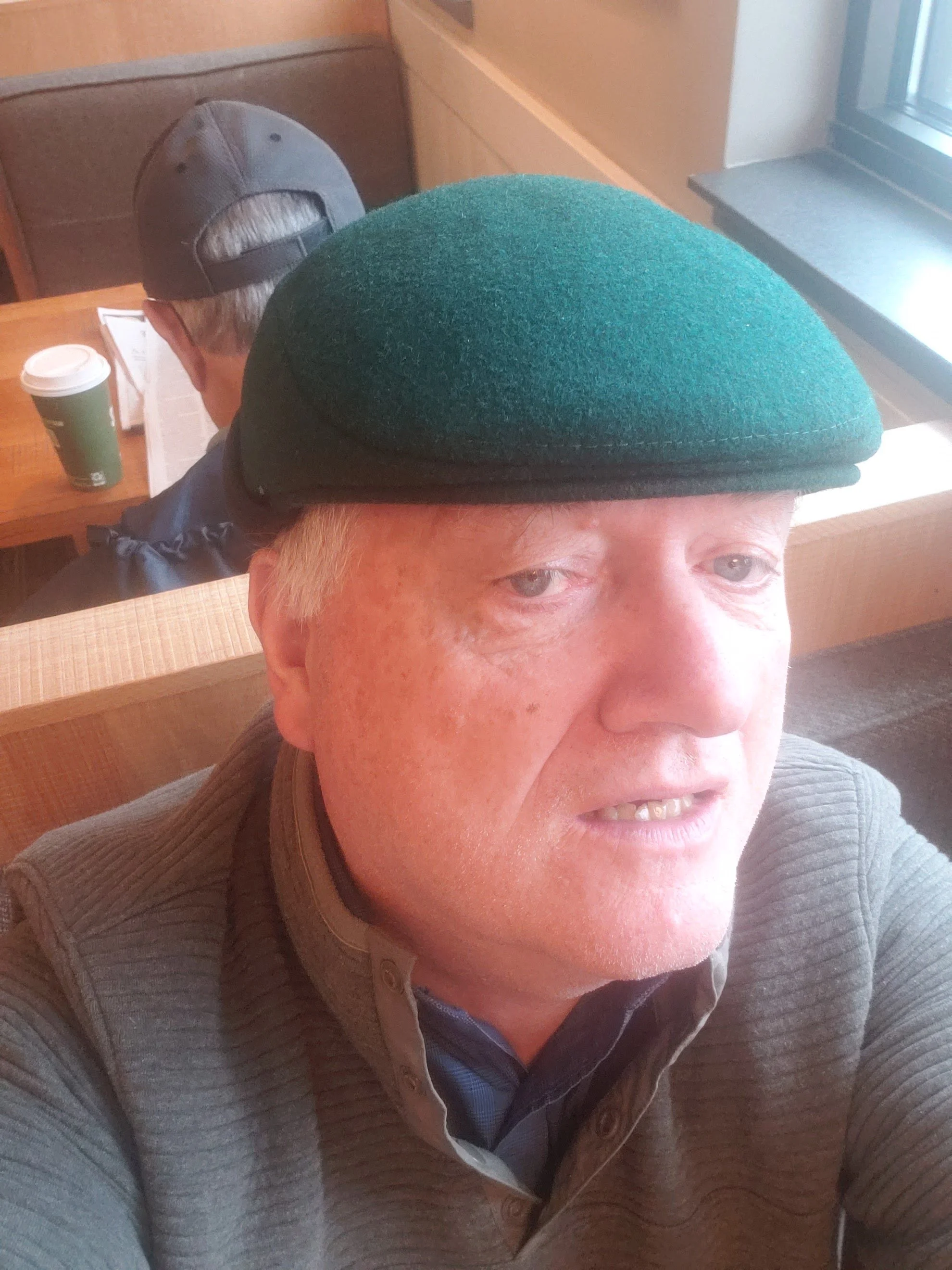 Local Boston tour guide seated inside historic New England cafe