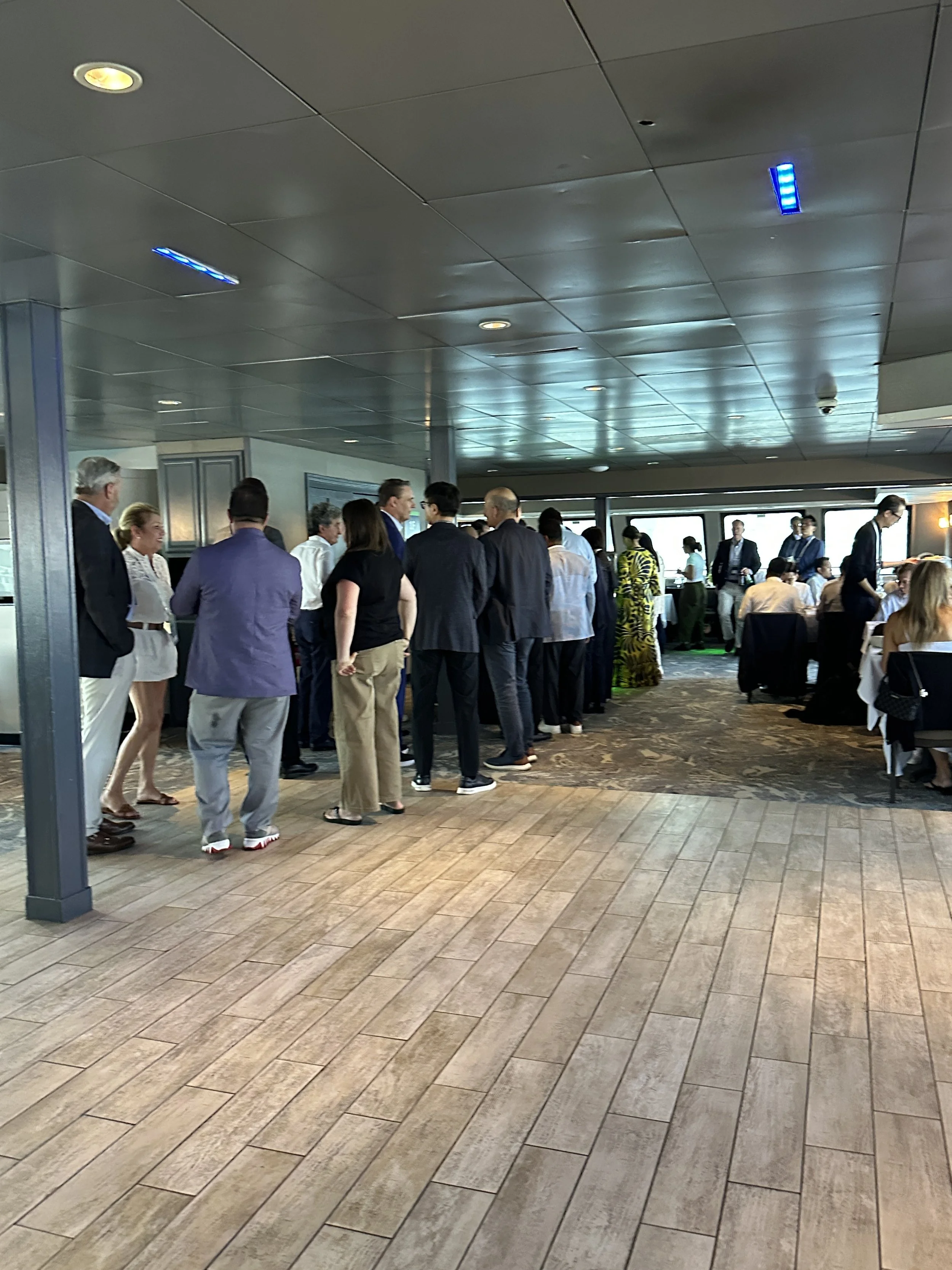 Corporate guets nertworking aboard a private Boston harbor event hosted by Boston Private Tours