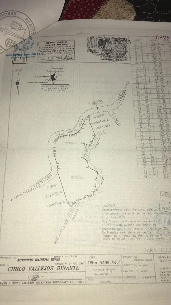 A detailed land survey map showing property boundaries, labels, a geographic location, and various notes, with stamped official markings and annotations.