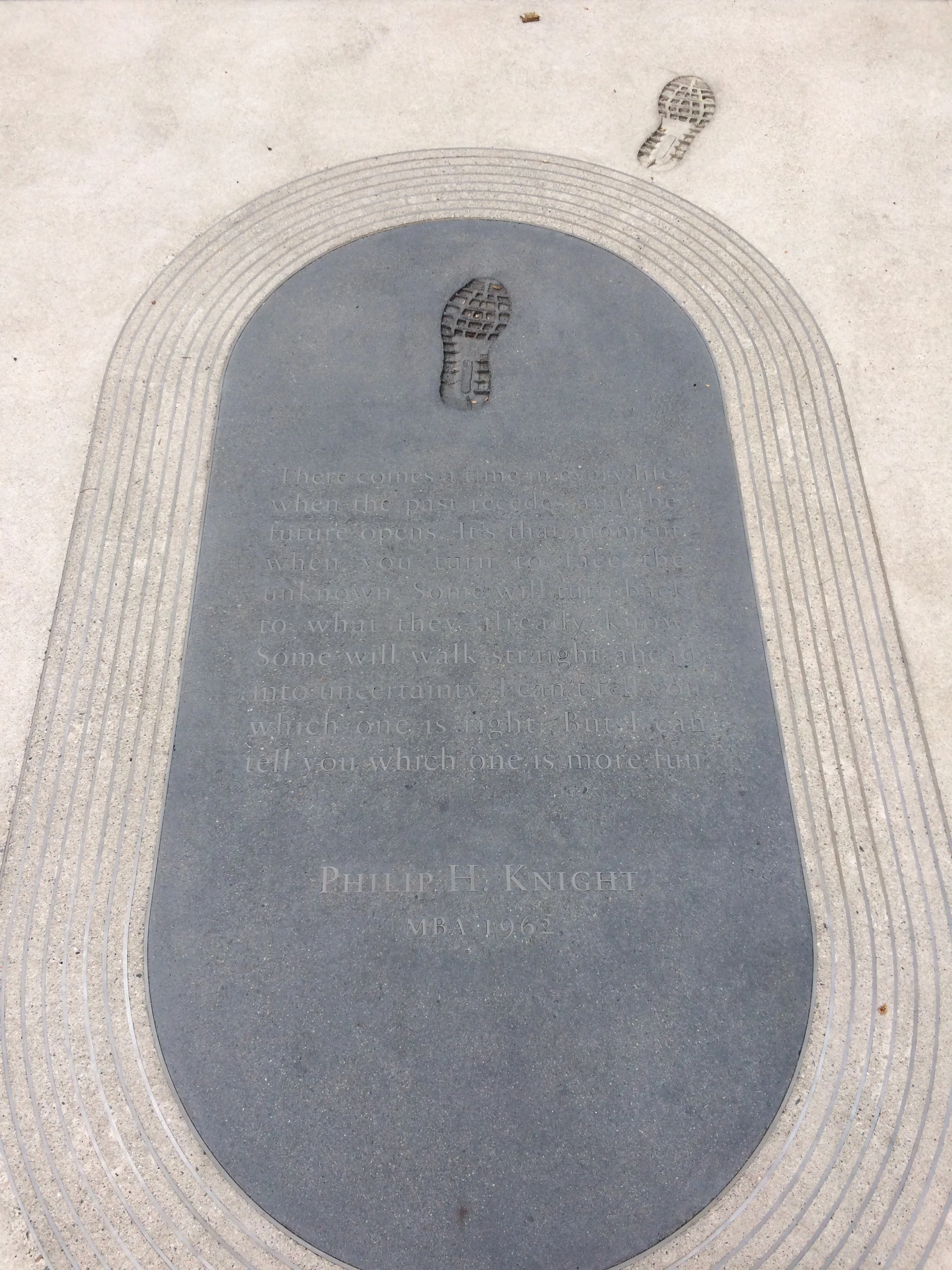 Stanford Graduate School of Business, Nike co-founder Philip Knight's footprints are part of an art installation called Your Future Collaborators by artist Peter Wegner, located on the walkway in front of the Bass Center