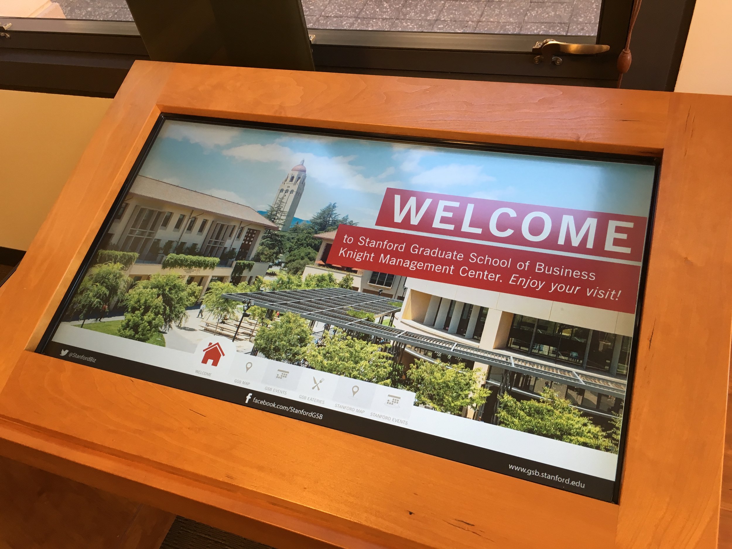 Interactive digital display screen at Stanford Graduate School of Business campus, with details like an interactive map, calendar and eateries.