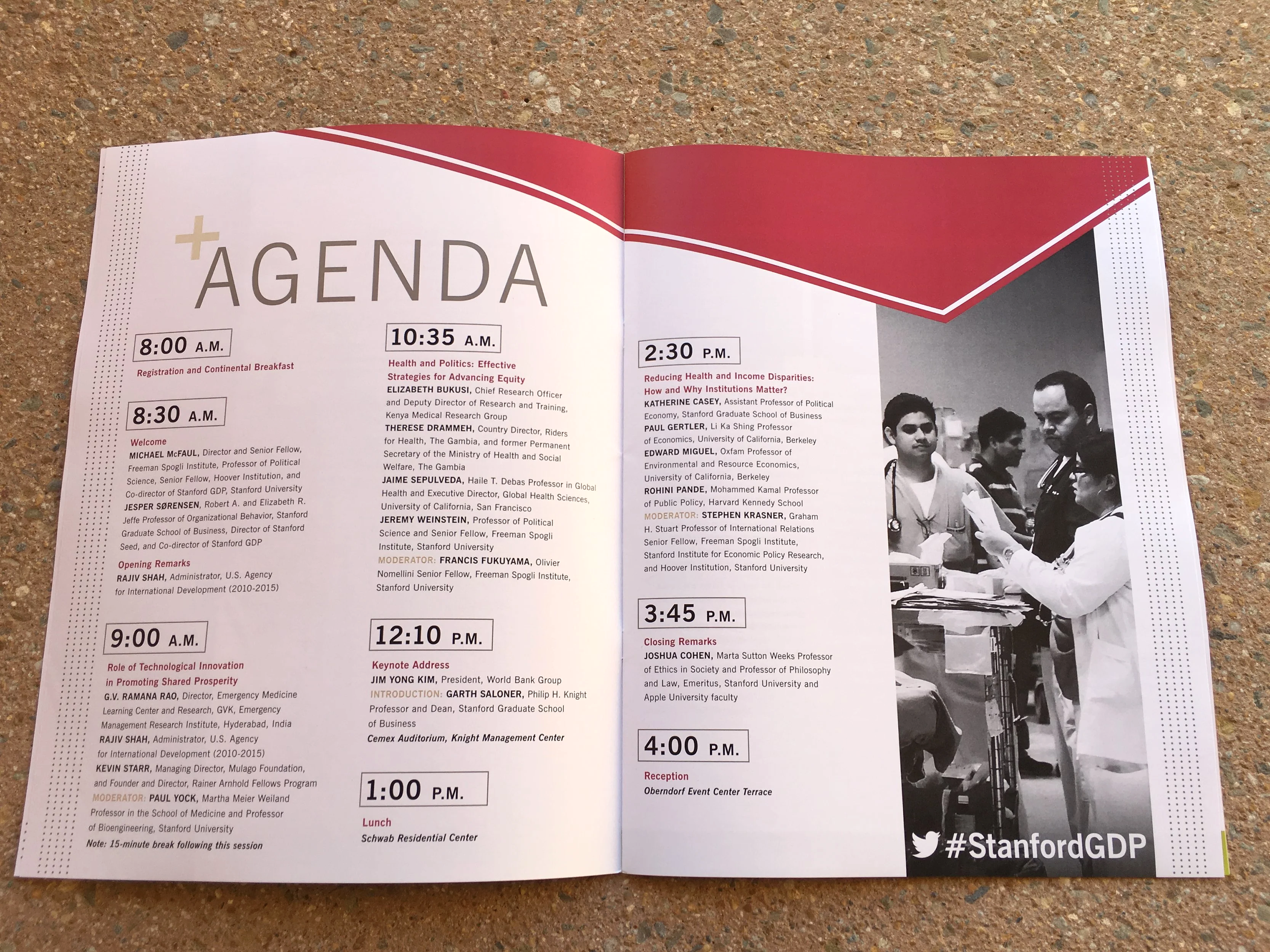 Open booklet showing an agenda for the Stanford GDP conference, with times and topics. The hashtag #StanfordGDP is visible on the bottom right.