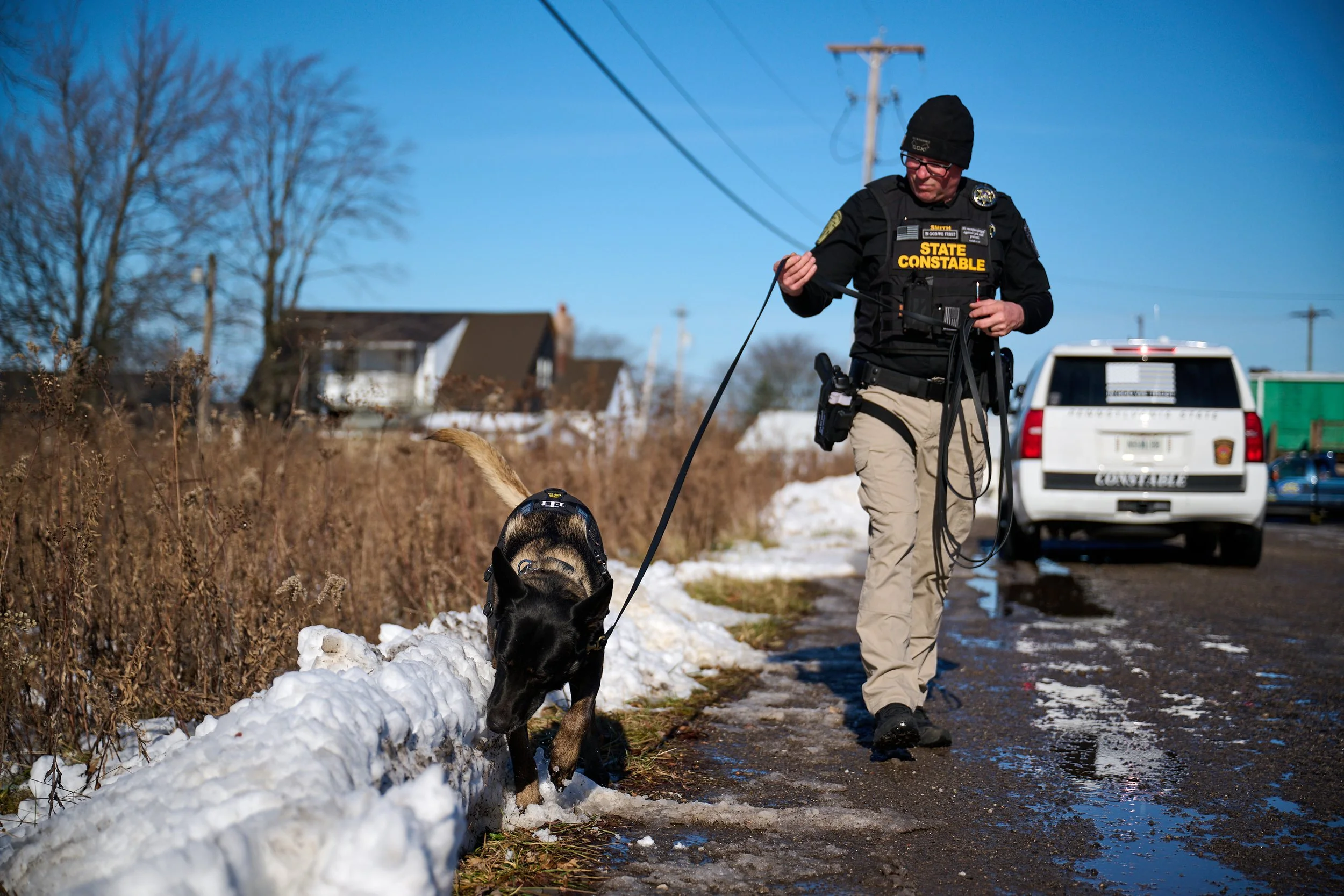 K-9 Blade and PSC Casey Smith searching a roadside for a discarded firearm or component