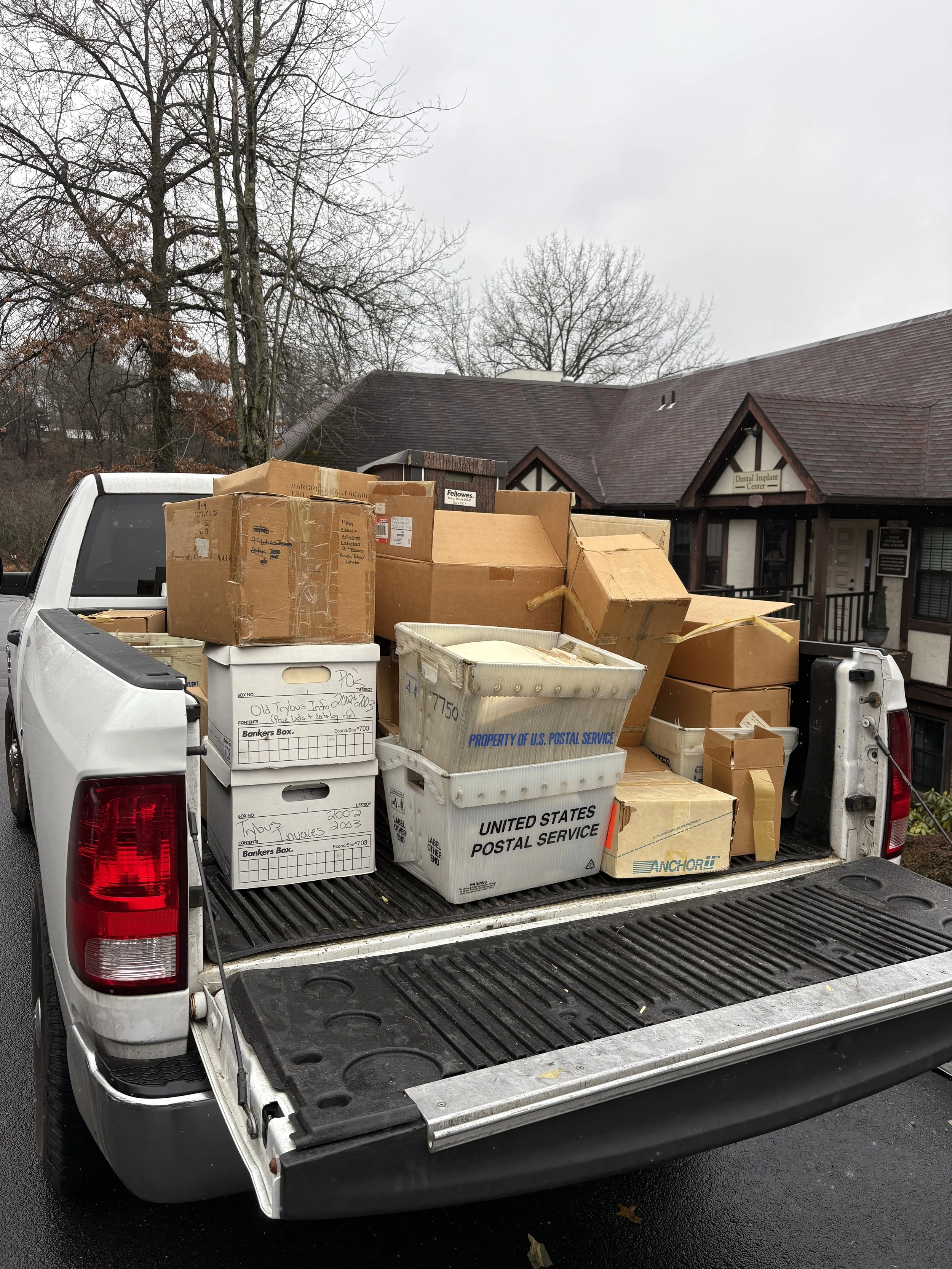 Pickup truck filled with numerous boxes, including USPS and Amazon branded packages in Pittsburgh, PA