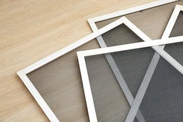 Multiple empty photo frames stacked on a wooden surface.