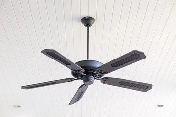 Black ceiling fan with five blades installed on a white ceiling