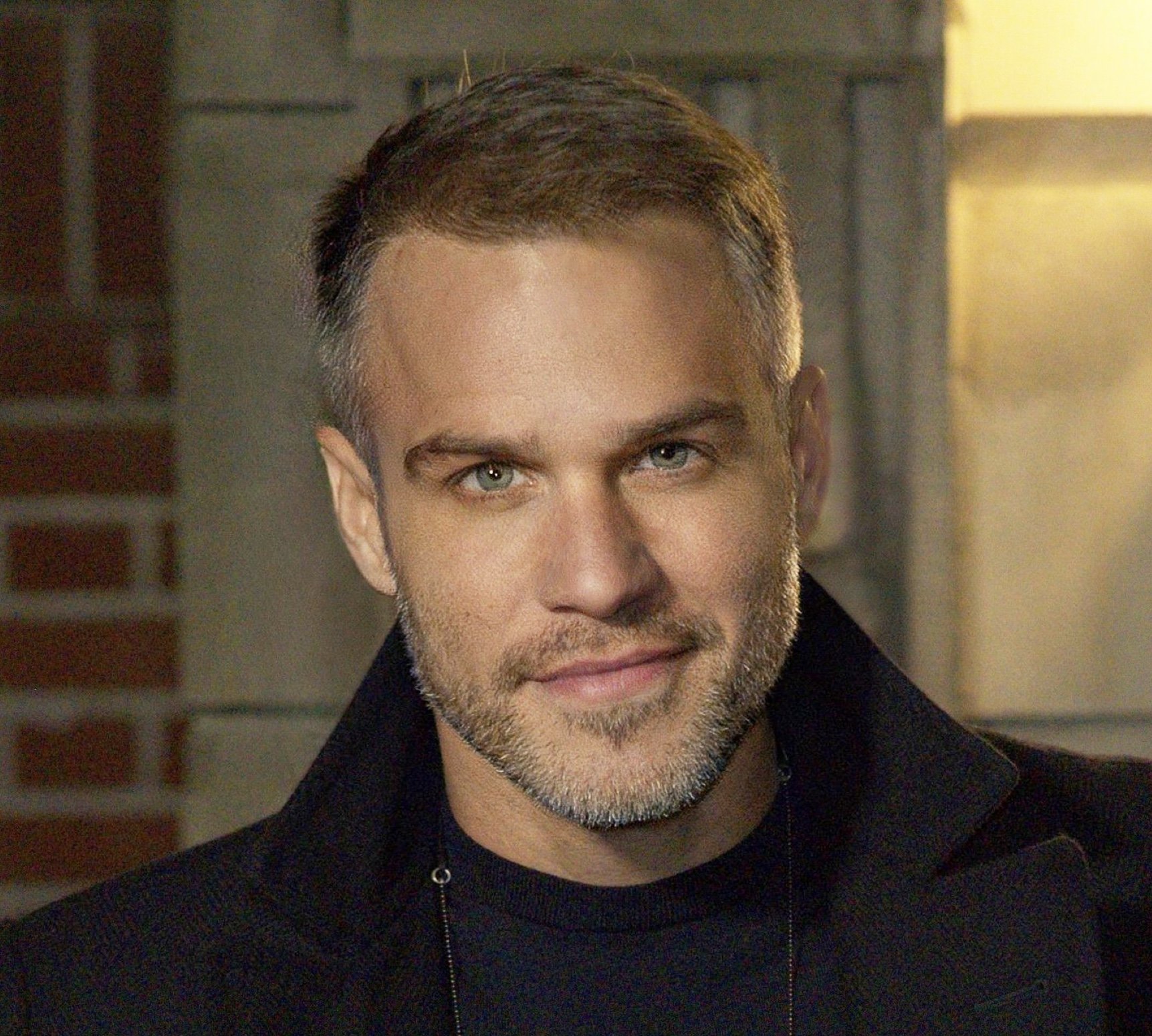 American-Greek-EU actor Taso Mikroulis Sag/aea actor in green black coat, hazel eyes, grey mixed brunette 40s male