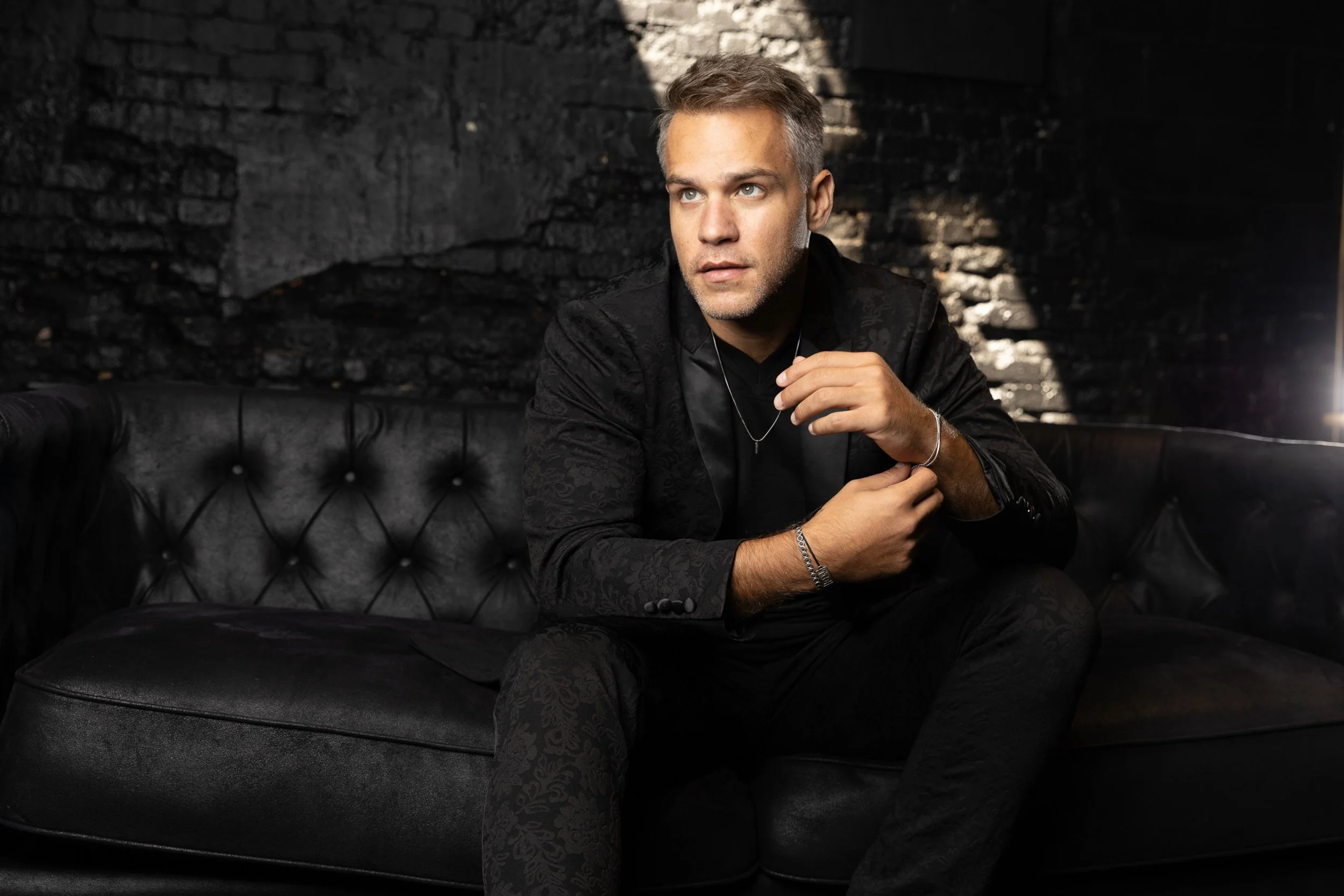 American-Greek-EU actor Taso Mikroulis Sag/aea actor inblack jacket hazel eyes, grey mixed brunette 40s male