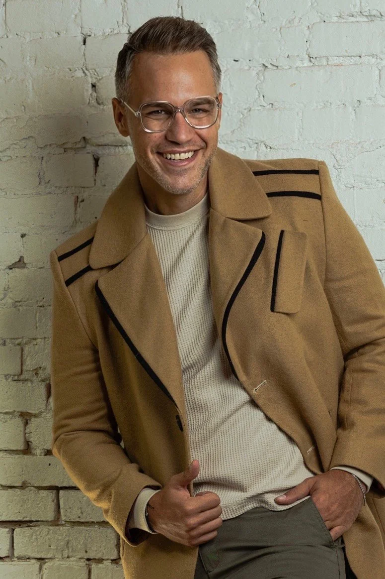 American-Greek-EU actor Taso Mikroulis Sag/aea actor in a beige coat and glasses, smiling, grey mixed brunette 40s male