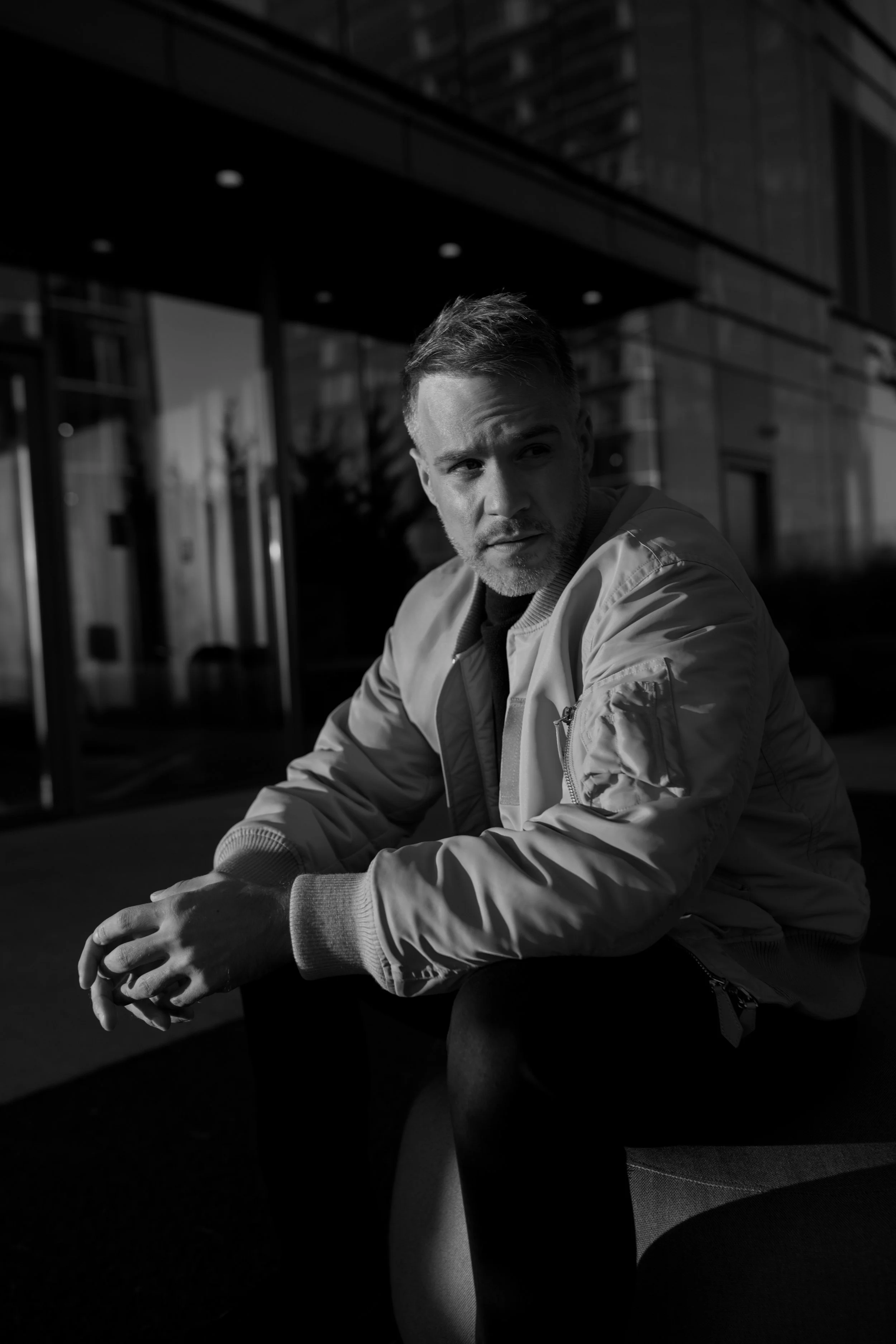 American-Greek-EU actor Taso Mikroulis black and white photo, grey mixed brunette 40s male