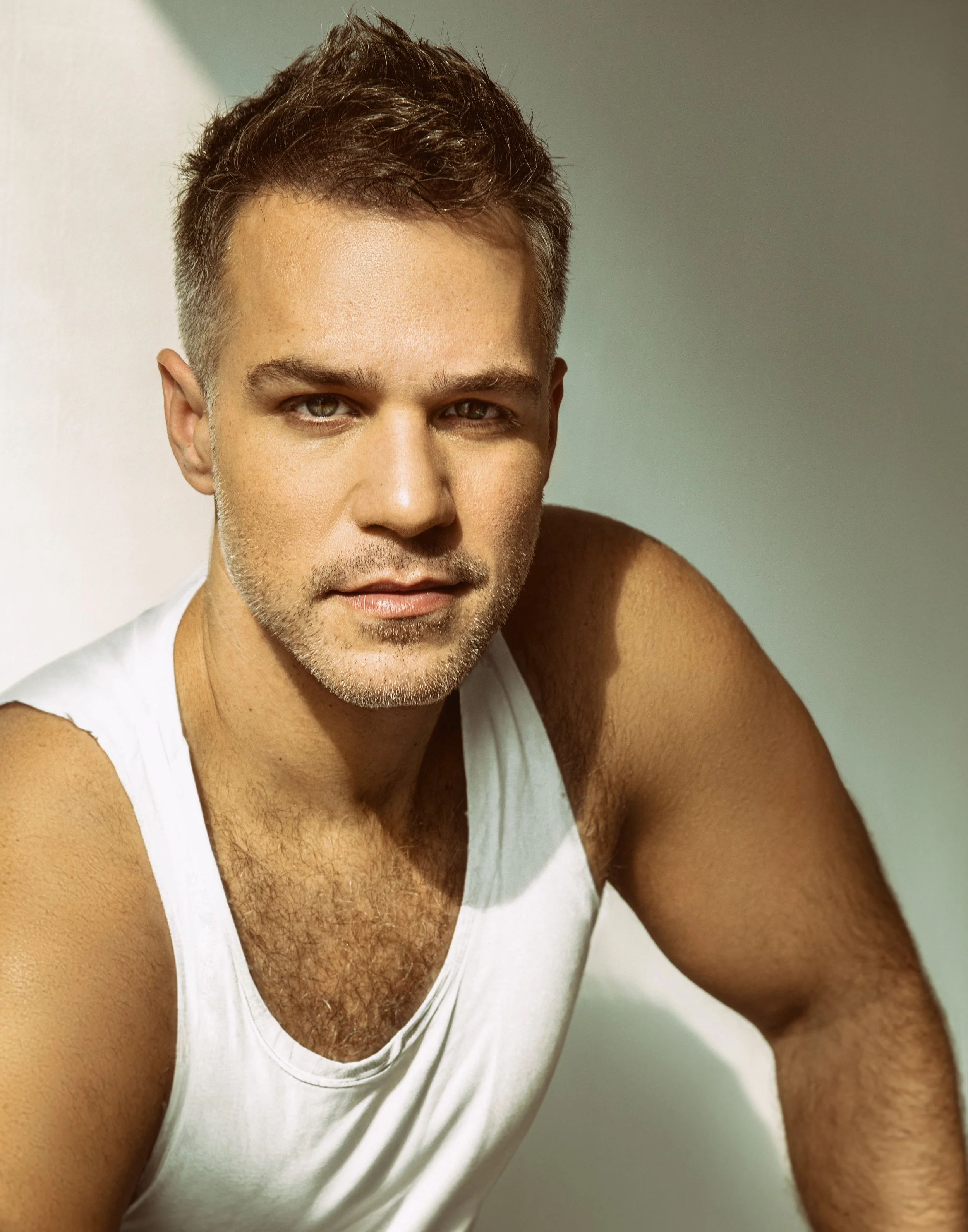 American-Greek-EU actor Taso Mikroulis Sag/aea actor in a white T-shirt, smiling, grey mixed brunette 40s male